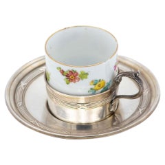 Porcelain teacup with silver saucer