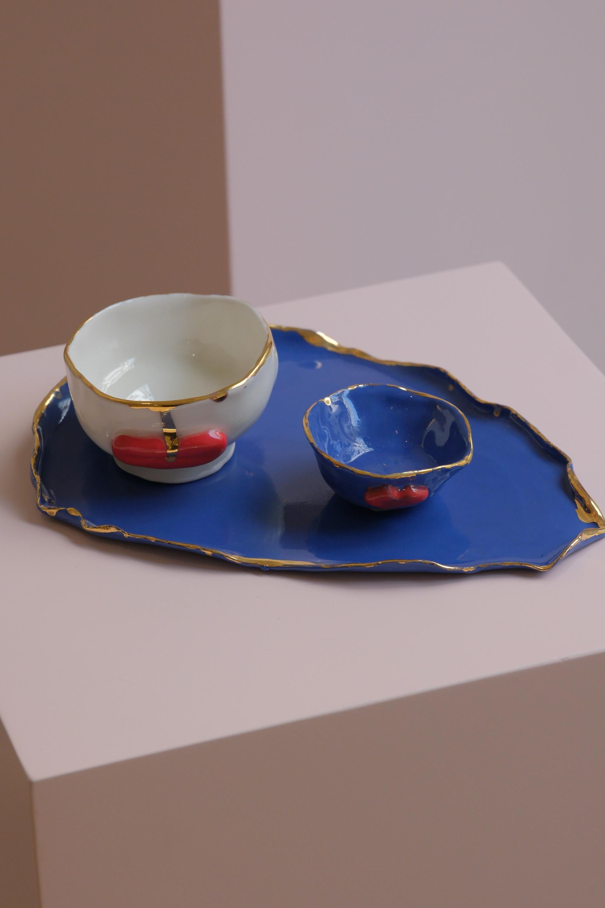 This is a unique plater in white porcelain , glaze and gold lustre by artist designer Hania Jneid. It is Hand built and hand painted by the artist. A sugar pot and an espresso cup set comes with the plater
This coffee set is part of the Lips