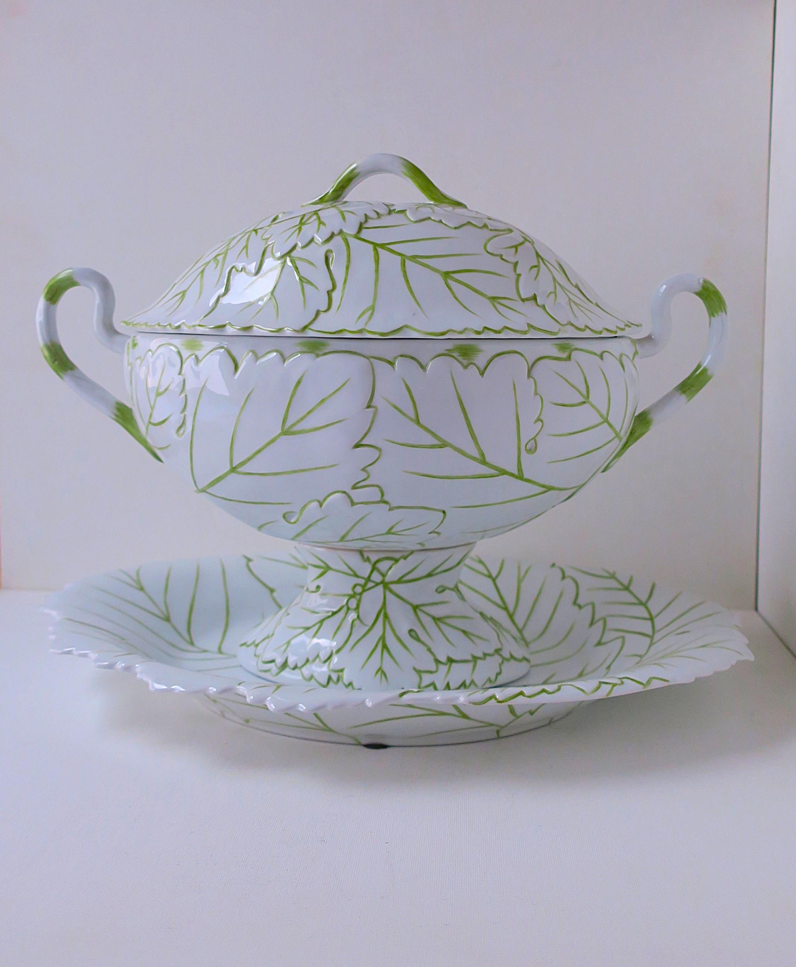 A beautiful decorative three (3) piece set. A white porcelain urn with green leaf design from Chelsea House, Inc., circa late-20th century to early-21st century. Set includes underplate, urn, and lid. Piece has a raised decorative leaf design,
