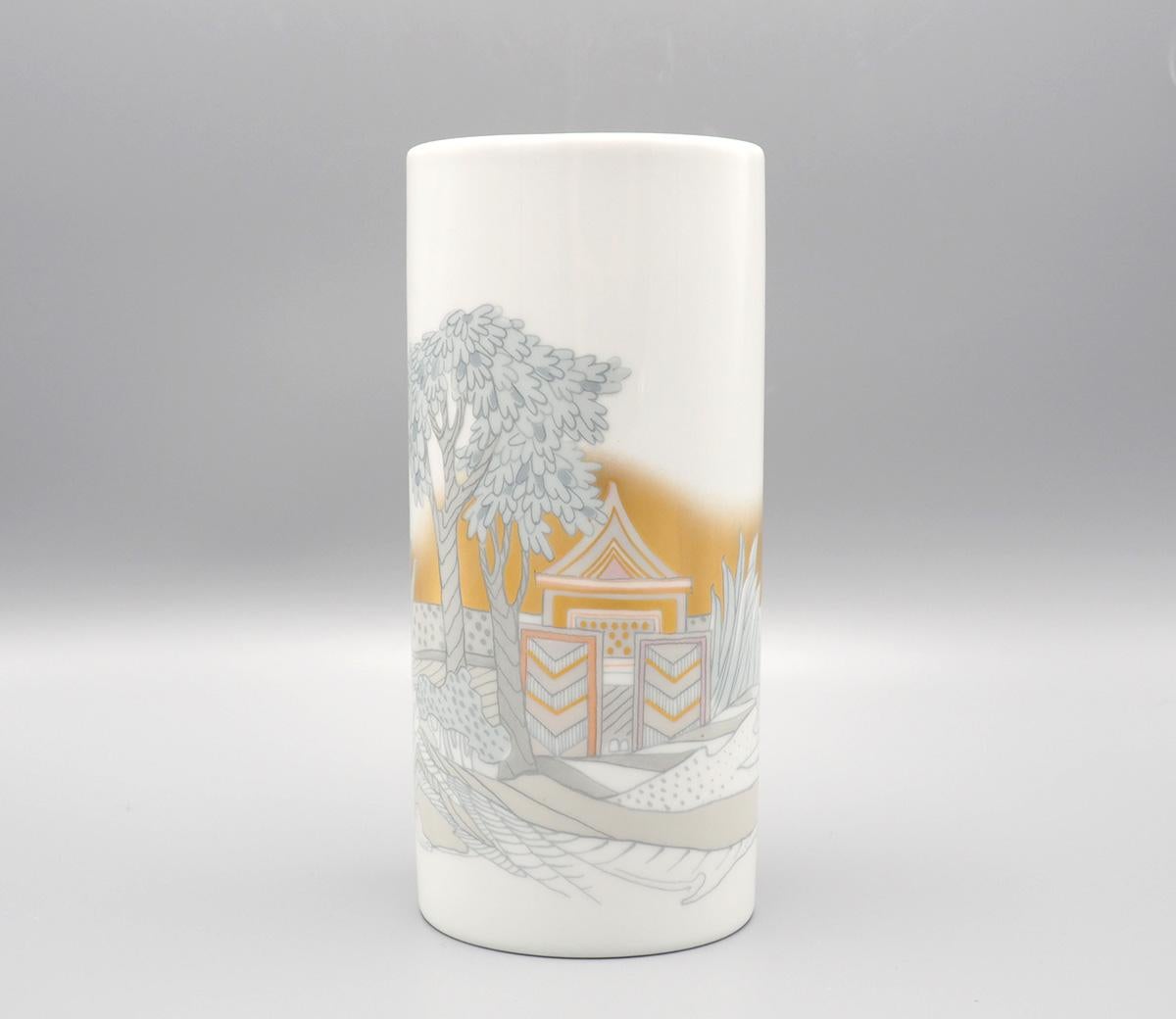 Porcelain Studio Linie (Line) art vase produced by Rosenthal Germany in the 1970s.

The cylinder-shaped vase has an abstract representation of a Japanese garden with a house and tree against a golden sky.

The decor is in beautiful soft shiny