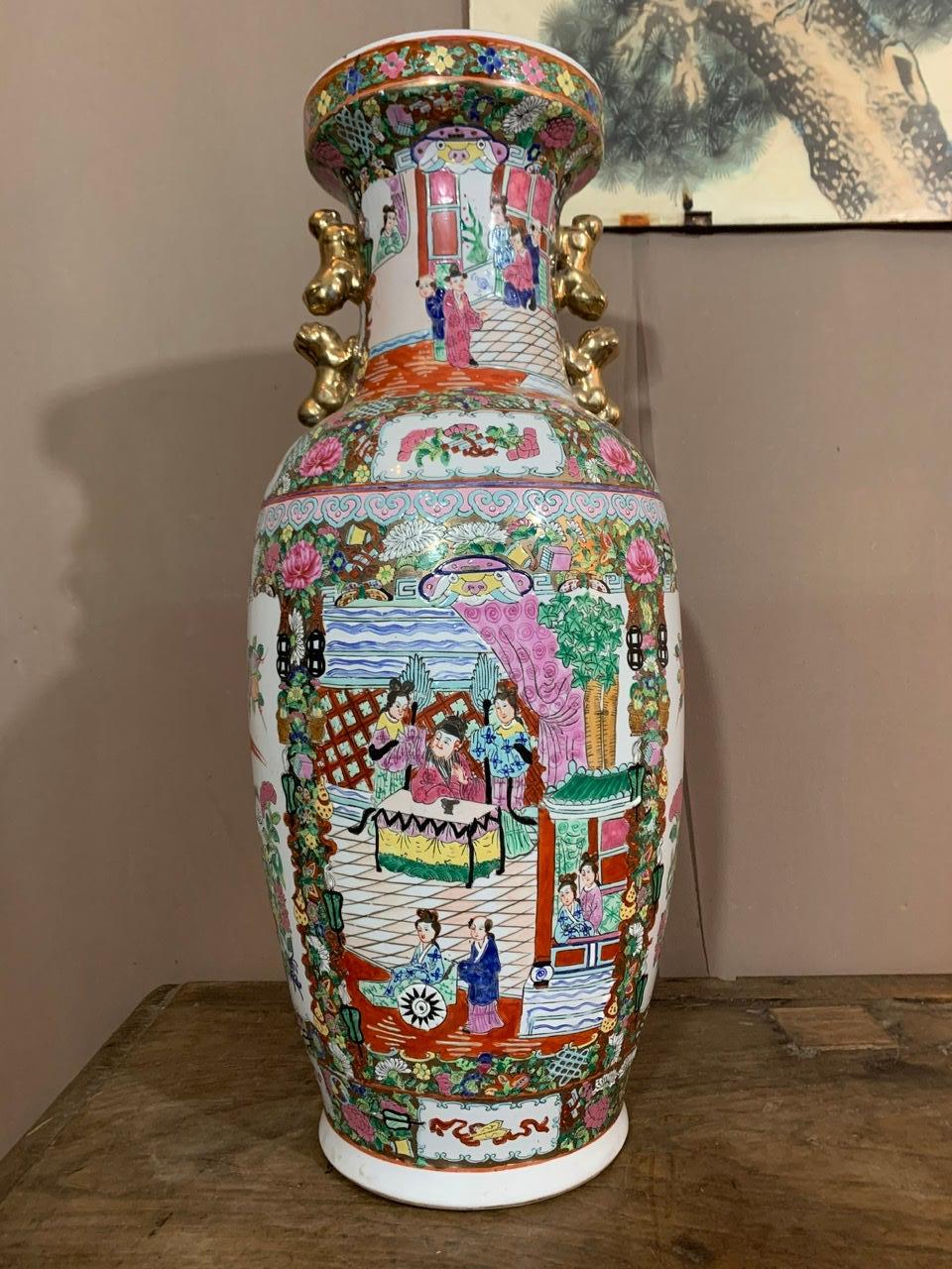 Beautiful Canton porcelain baluster vase with floral decoration and representation of court scenes in the reserves. It shows men and women in traditional Chinese dress. This vase has double handles on both sides, in the shape of golden 