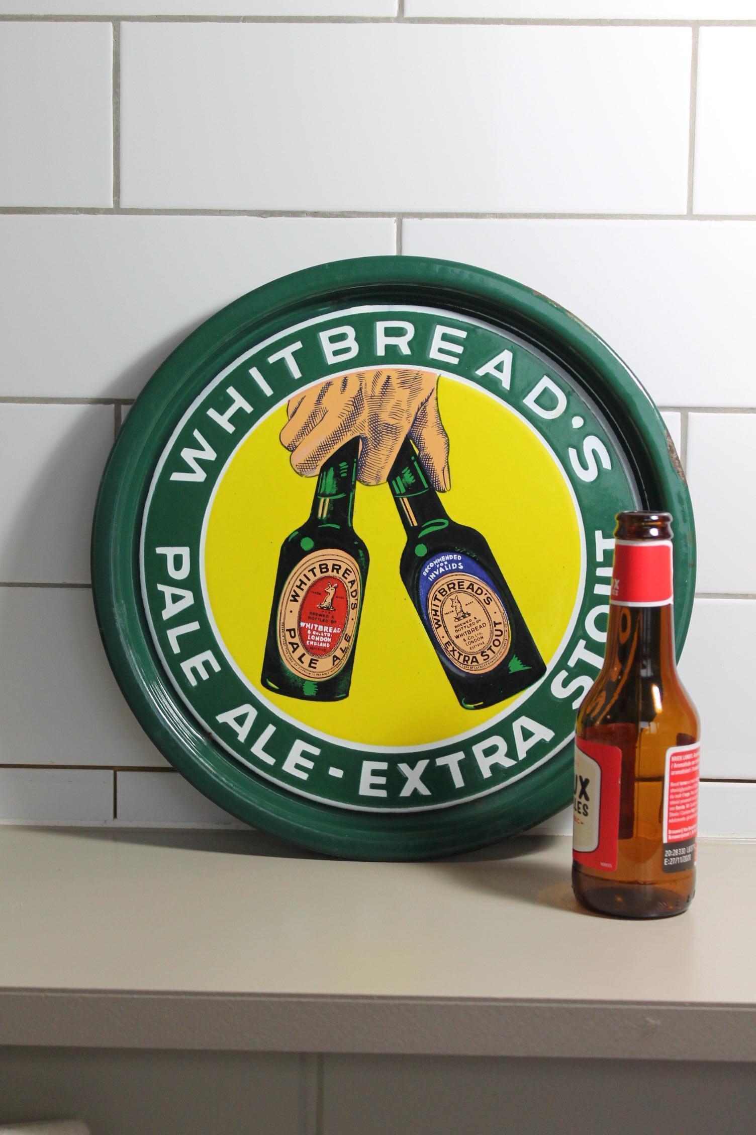 Mid-20th century enamel tray for Beer. 
This 1940s-1950s Pub Tray was made for Whitbread's Beer, 
the Pale Ale and the extra stout. 
This Enamel sign - Porcelain sign is eye-catching due the colors green and yellow and by the design : a hand