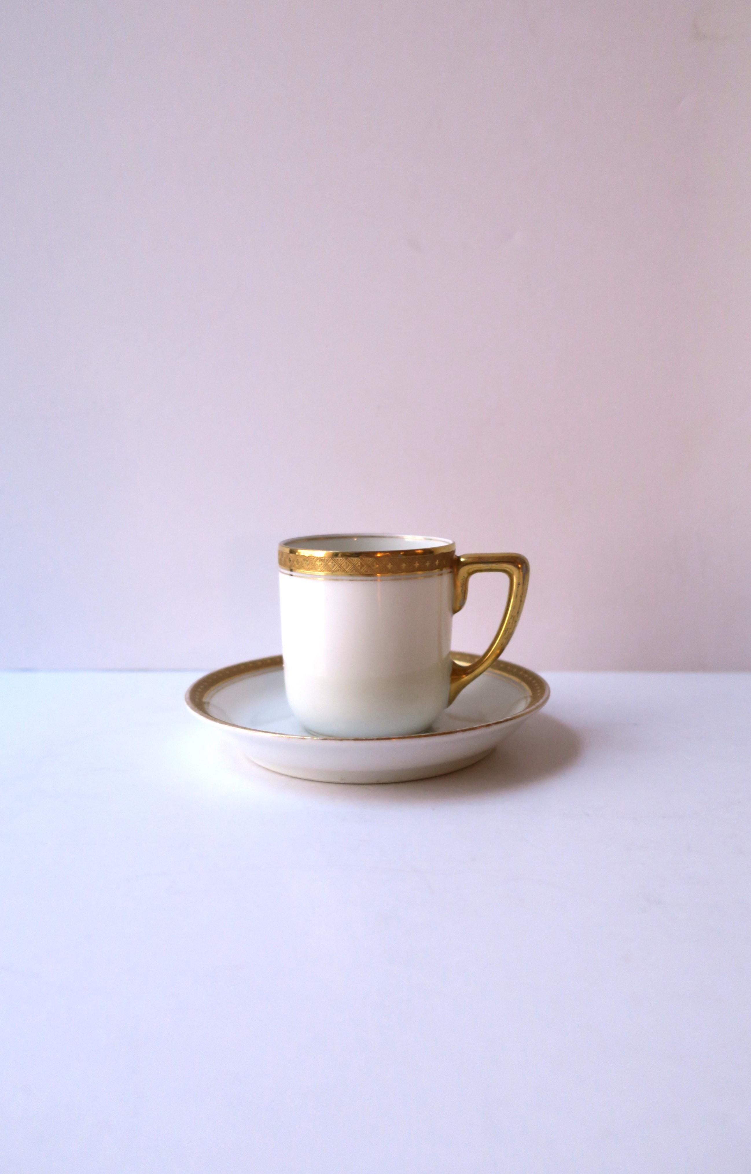 A beautiful German white porcelain and gold gilt coffee espresso or tea demitasse cup and saucer by Rosenthal, circa early-20th century, Germany. This white porcelain cup and saucer has a slightly raised gold gilt relief detail around cup and saucer