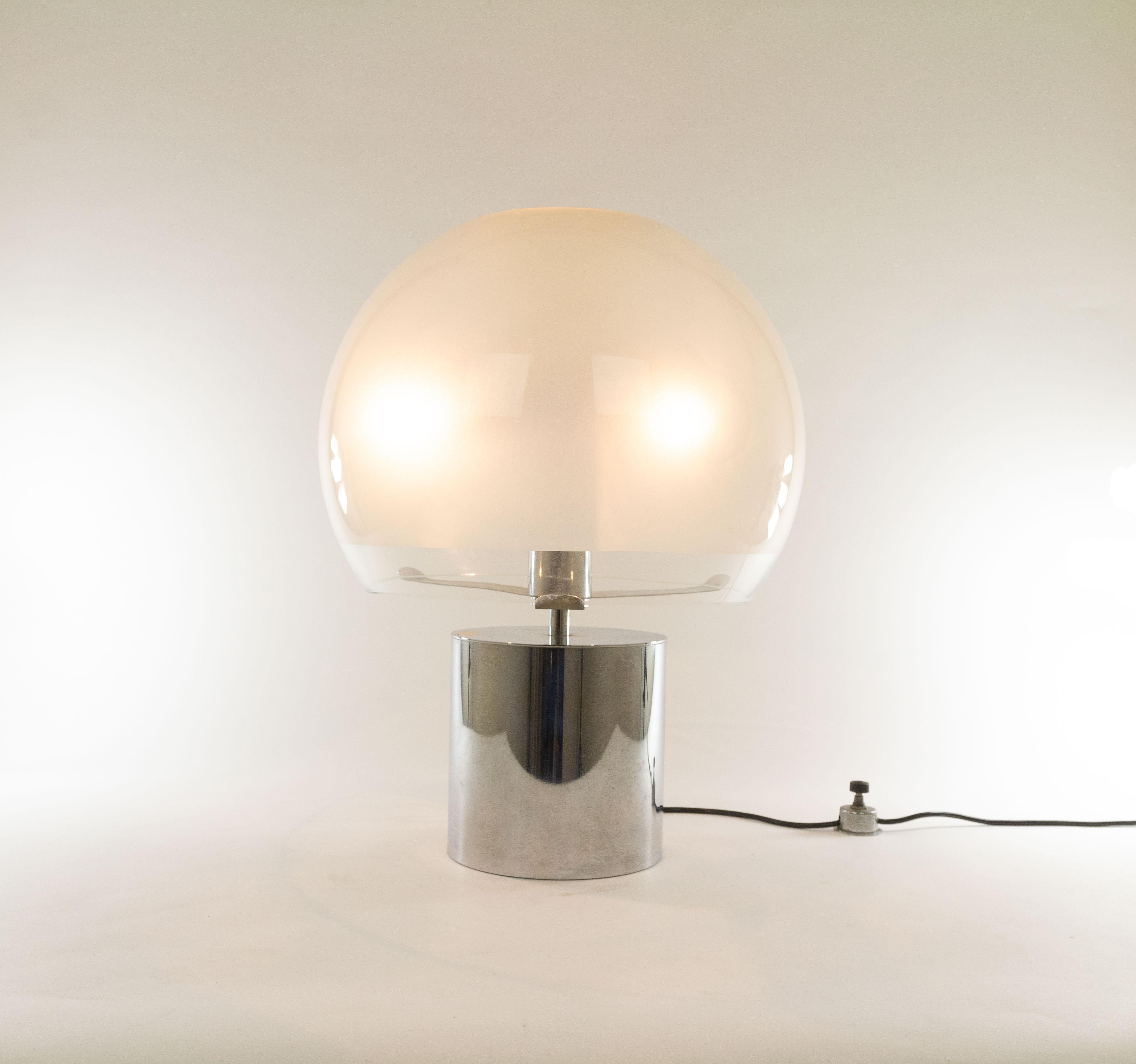 Porcino table or floor lamp designed by Luigi Caccia Dominioni for Azucena, 1966. A timeless classic piece.

The model consists of a cylindrical, silver coloured base, which supports a sphere-like diffuser. The shade, which is made of frosted and