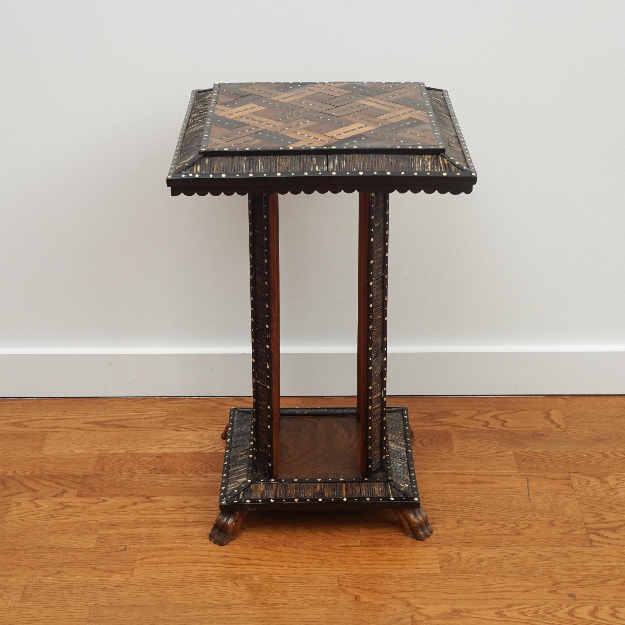 The small-scale antique accent table, shown here, is a true work of art. Combining ebony, ivory dots and tropical wood inlays throughout, the table top, legs and base are enhanced with porcupine quill detailing. The table is newly restored and in