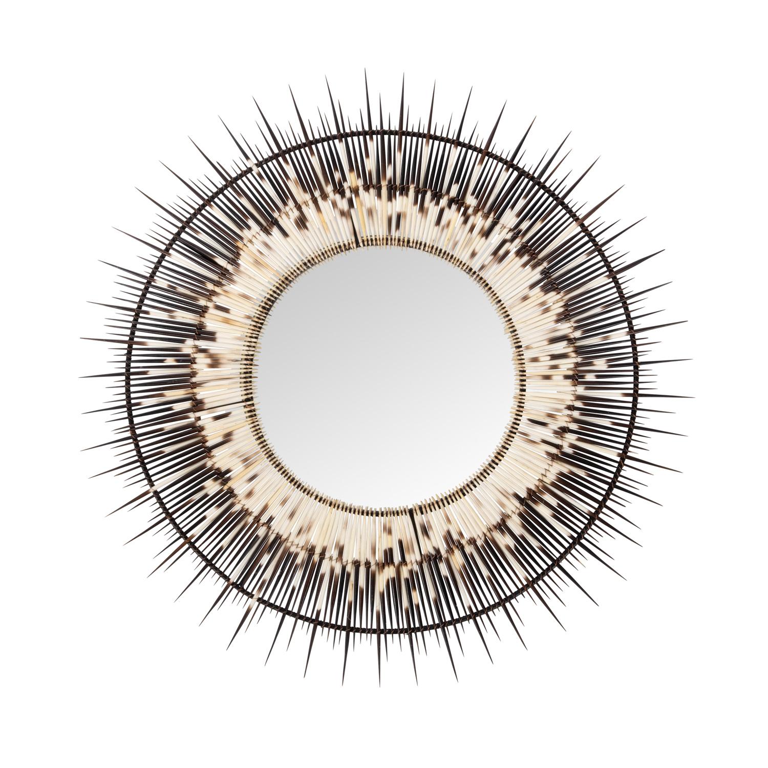 An earthy yet edgy take on the classic starburst mirror, this striking piece was handcrafted from genuine porcupine quills, naturally shed and collected on a farm in Cape Town, South Africa. Due to the use of natural materials, each piece is unique