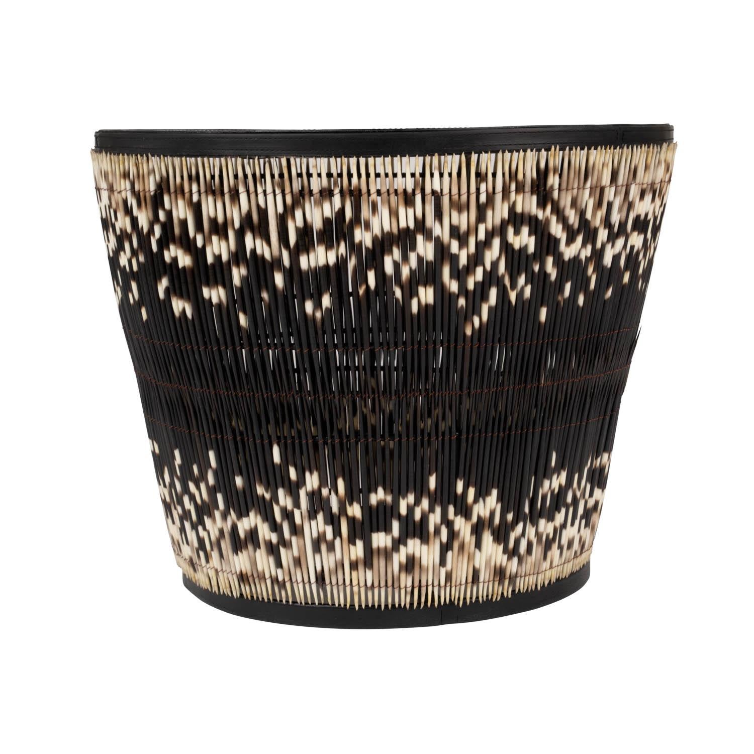 Unique and exciting, this side table is handcrafted of powder-coated metal with genuine porcupine quill. Humanely gathered, the quills form a stunning exterior to the table, with two rows secured into a beguiling pattern allowing the natural color