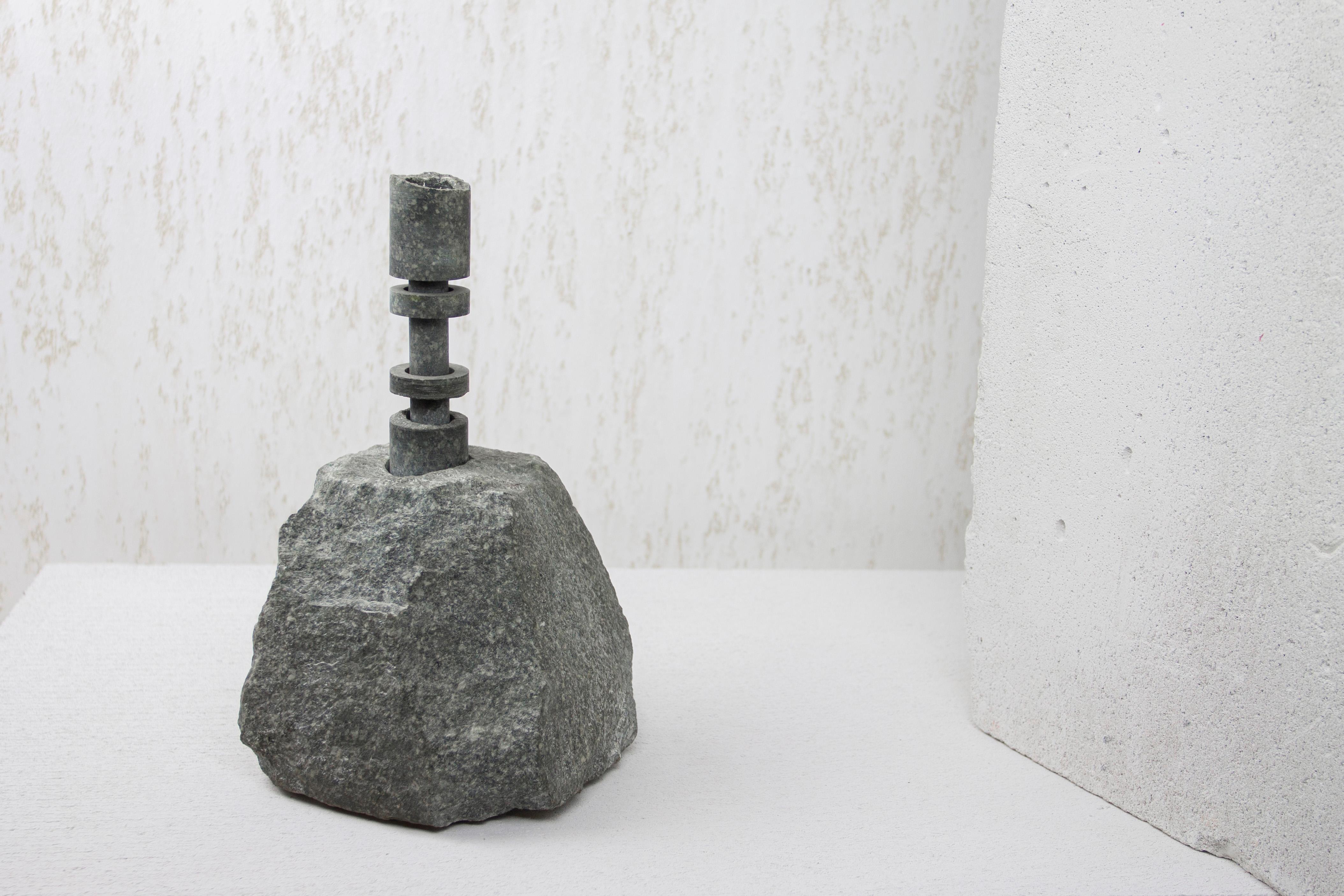 Porfier Abra Candelabra by Studio DO
Dimensions: D 14 x W 13 x H 25.5 cm
Materials: Stone, aluminum.
5.7 kg.

Stone and fire are connected in an ageless bond. A sparkle created by clashing two stones with each other has been igniting fire over