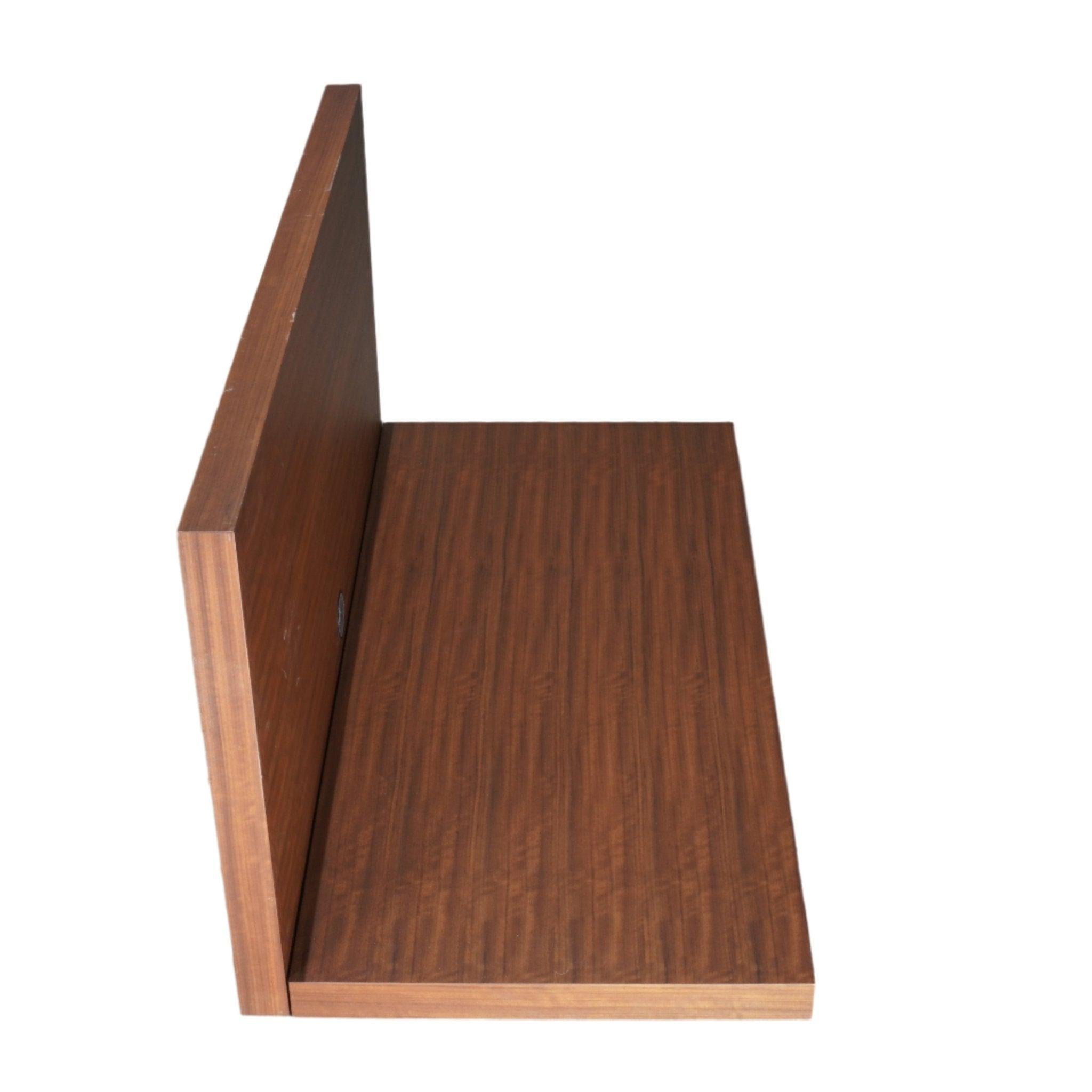 The Porro Web Shelf, designed by Piero Lissoni, is a minimalist masterpiece that combines form and function with elegance. Mounted seamlessly to the wall, its sleek, floating design is perfect for contemporary living spaces. The rich walnut finish