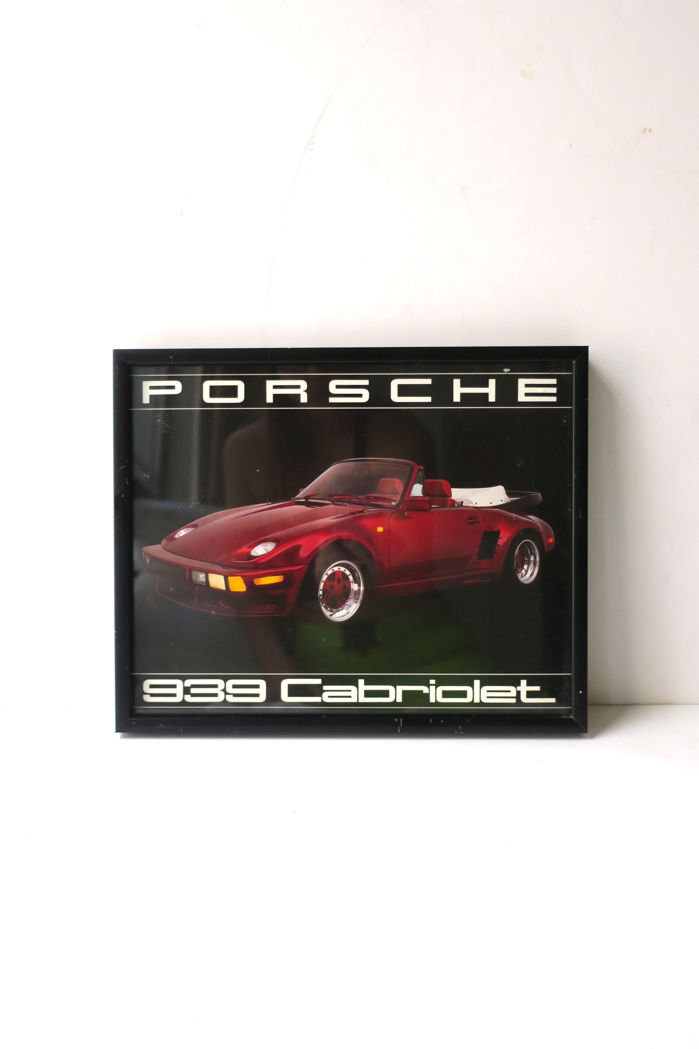 A vintage framed poster of a Porsche 939 Cabriolet, 1987. This poster wall art piece has protective glass front and a black metal frame. Dated on back July 7, 1987 as shown in last three images. Dimensions: 9.94