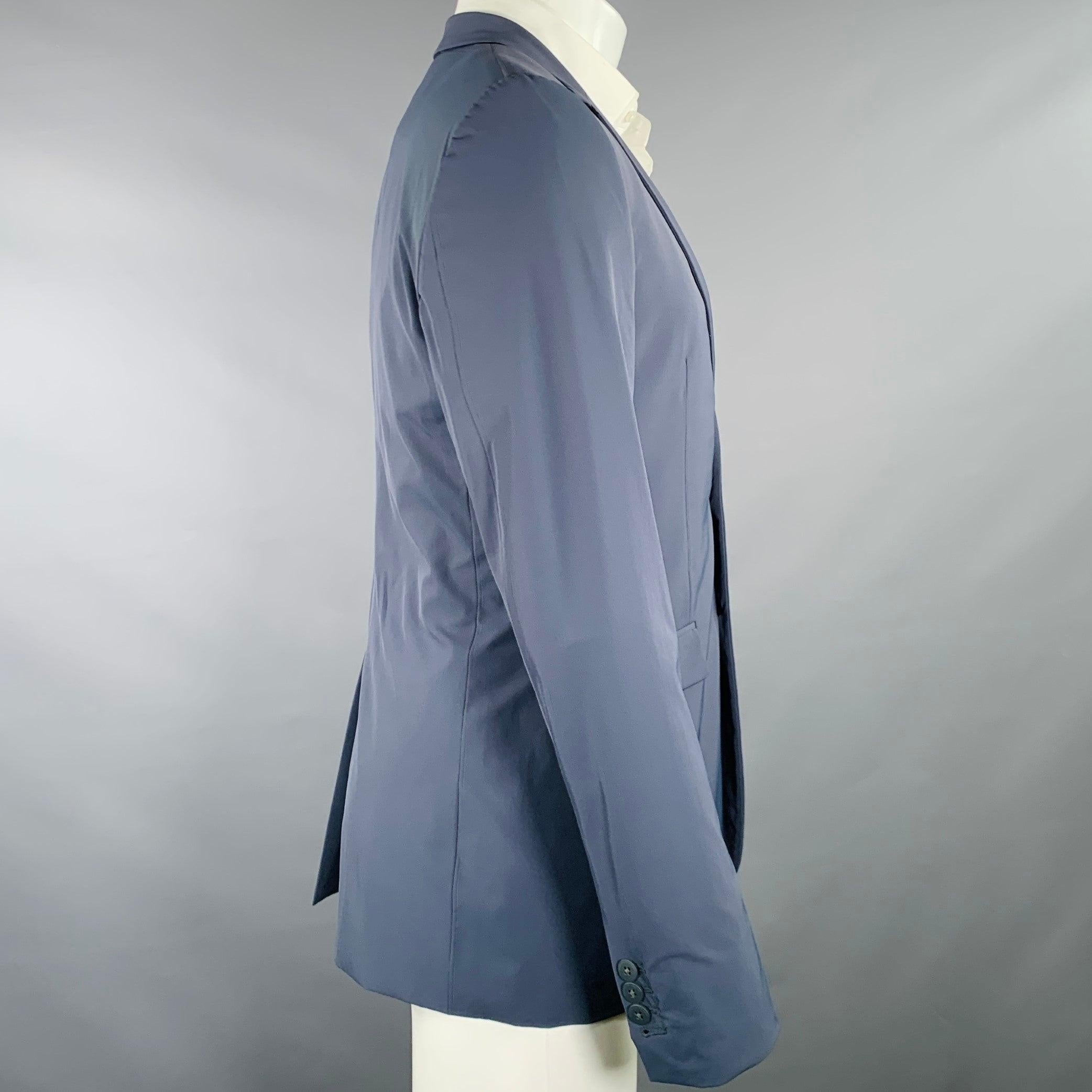 PORSCHE DESIGN sport coat
in a navy polyamide stretch blend fabric featuring a notch lapel, single vented back, and double button closure. Made in Portugal.Excellent Pre-Owned Condition. 

Marked:   IT 48 

Measurements: 
 
Shoulder: 17.5 inches