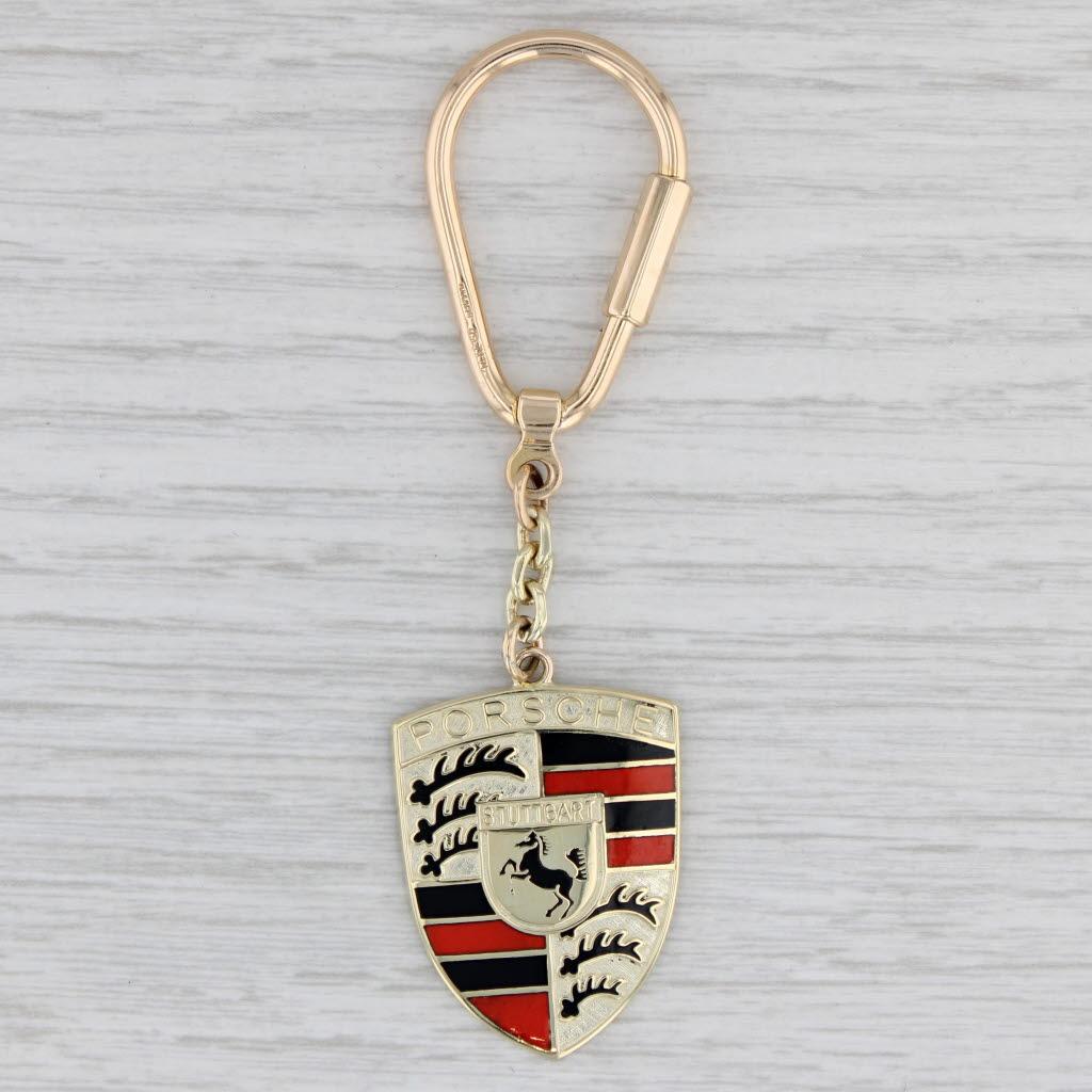 Material: Enamel
Metal: 14k Yellow Gold
Weight: 18.5 Grams 
Stamps: 14k Germany (stamped on lock and fob)
Closure: Screw Clasp
Measurements: 34.3 x 24 mm shield, 87.3 mm in total length