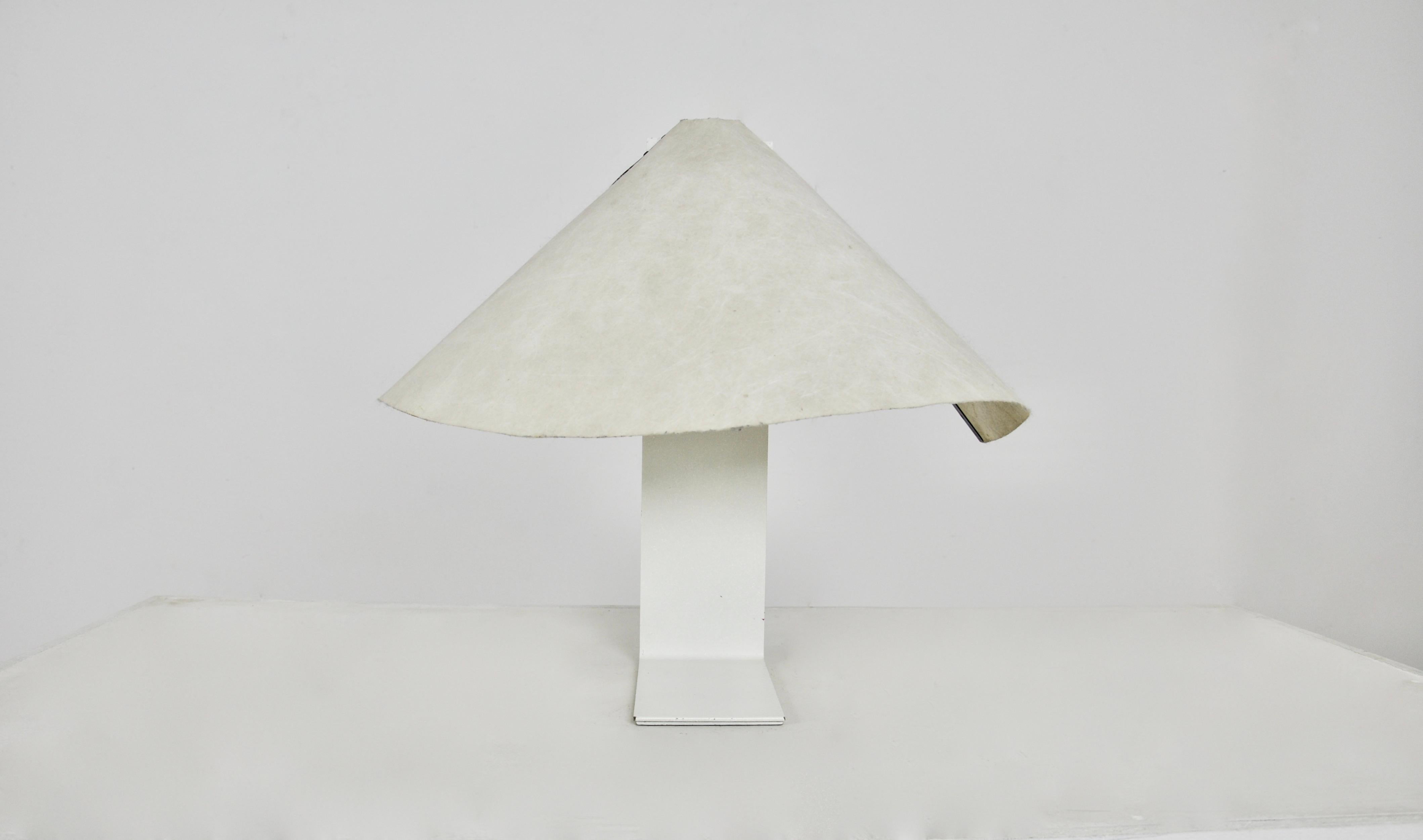 Lamp with white metal base and paper shade. Wear due to time and age of the lamp.
   