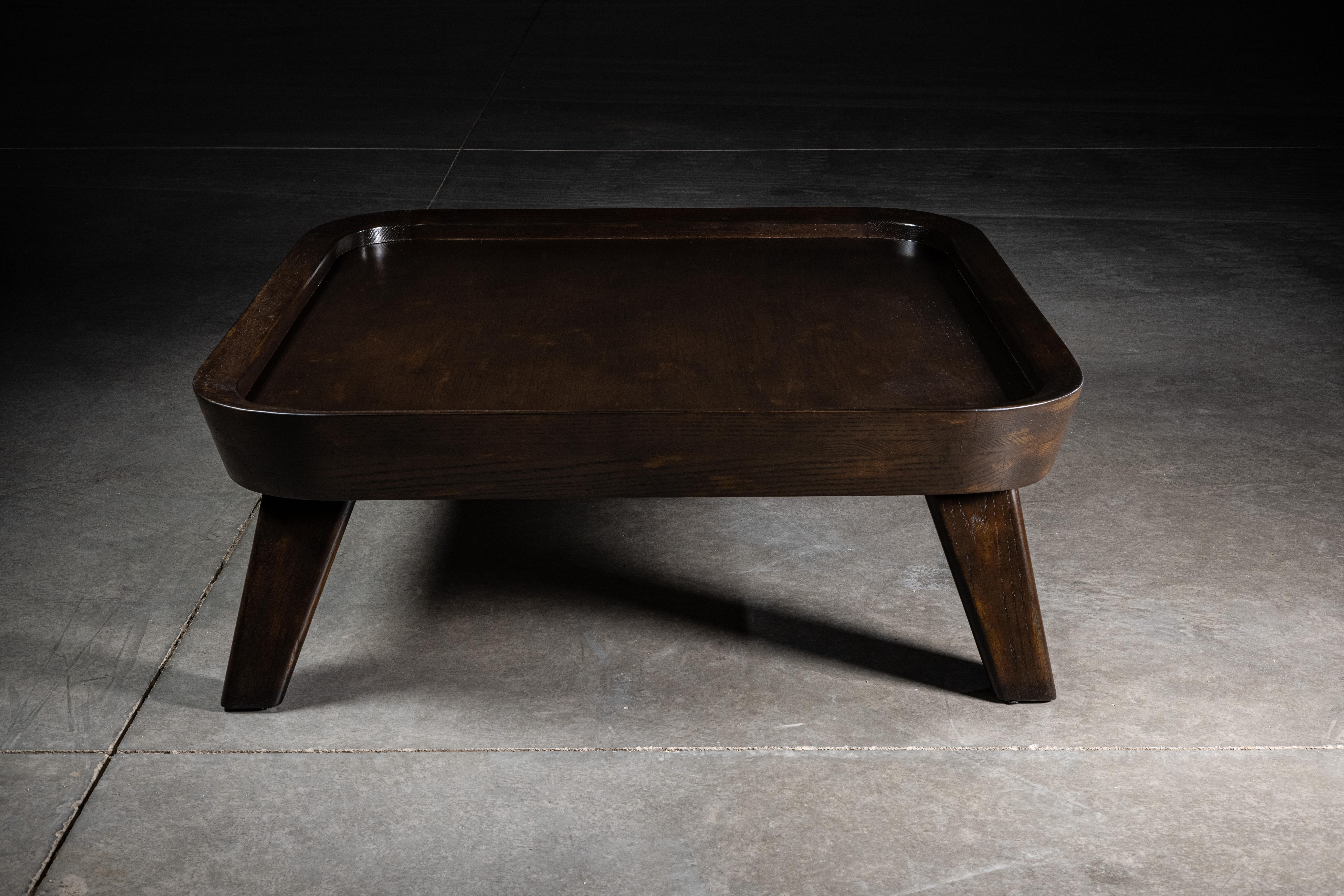 Brown oak coffee table, inspired in the organic designs of Clara Porset for whom the balance between an unapologetic exploration of modernity and a equally stubborn insistence on tradition was her very vision.


 