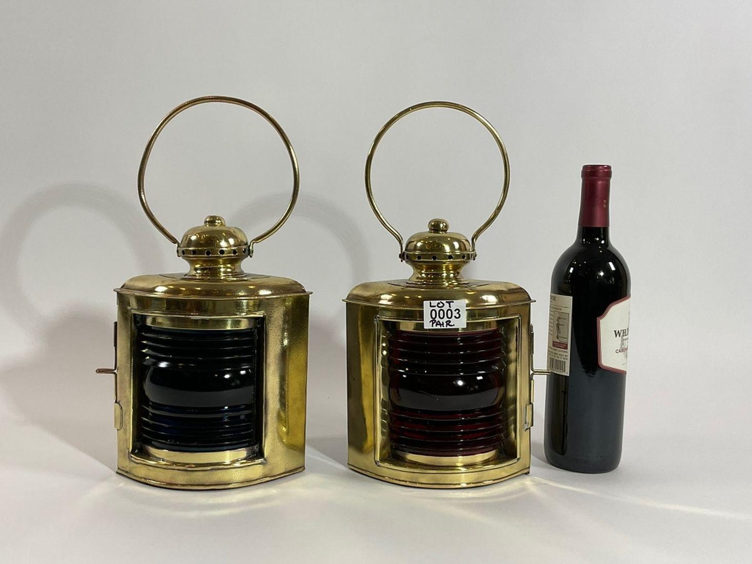 Fine pair of polished brass port and starboard boat lanterns with richly colored ruby red and blue lenses. Fitted with vented tops with hoop carry handles. Engraved on rear 