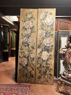 Two-leaf wooden door painted with floral decorations, italy