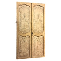 Carved and lacquered double-leaf door with painted panels, Italy