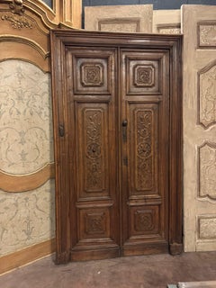 Walnut double door with frame, richly carved, italy
