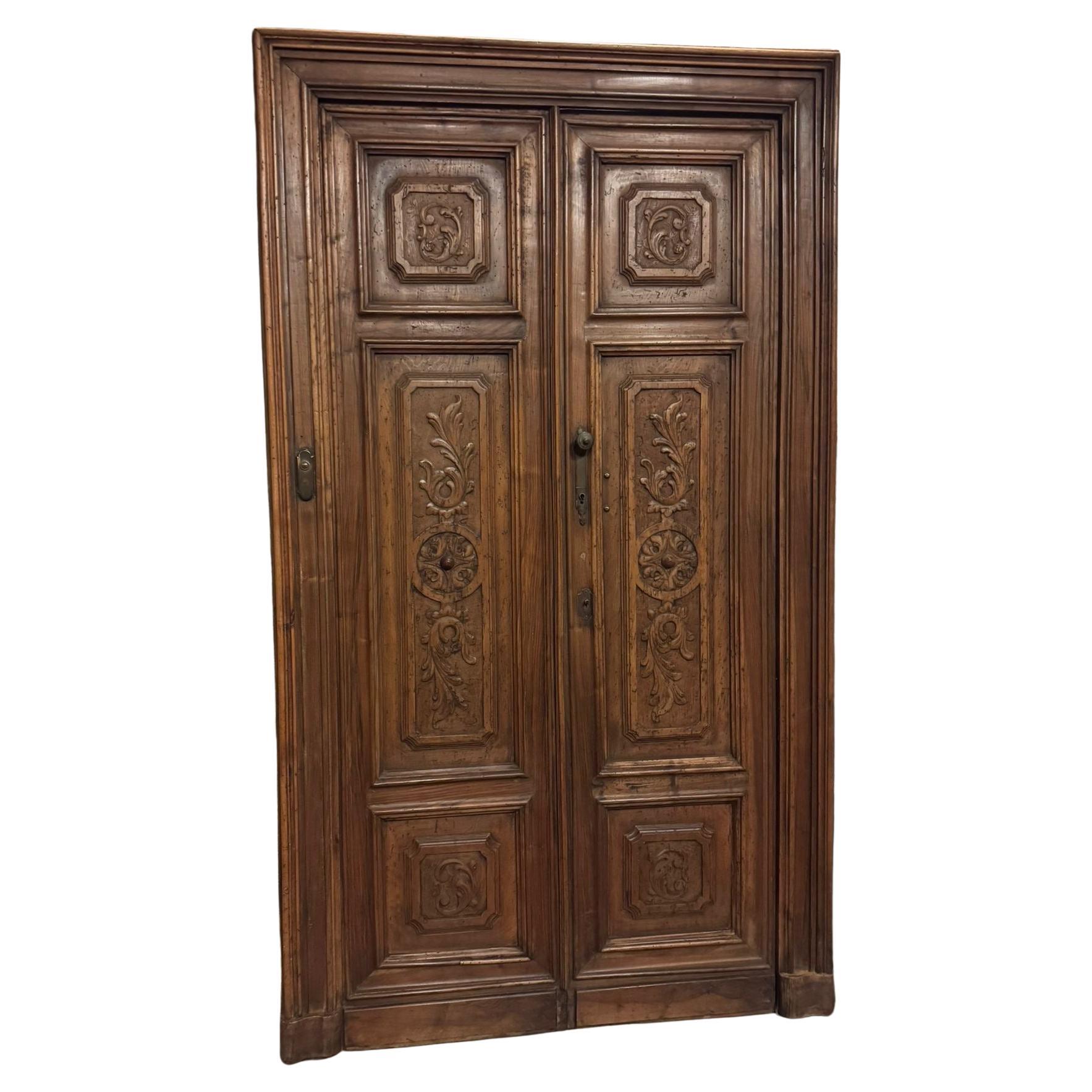 Walnut double door with frame, richly carved, italy