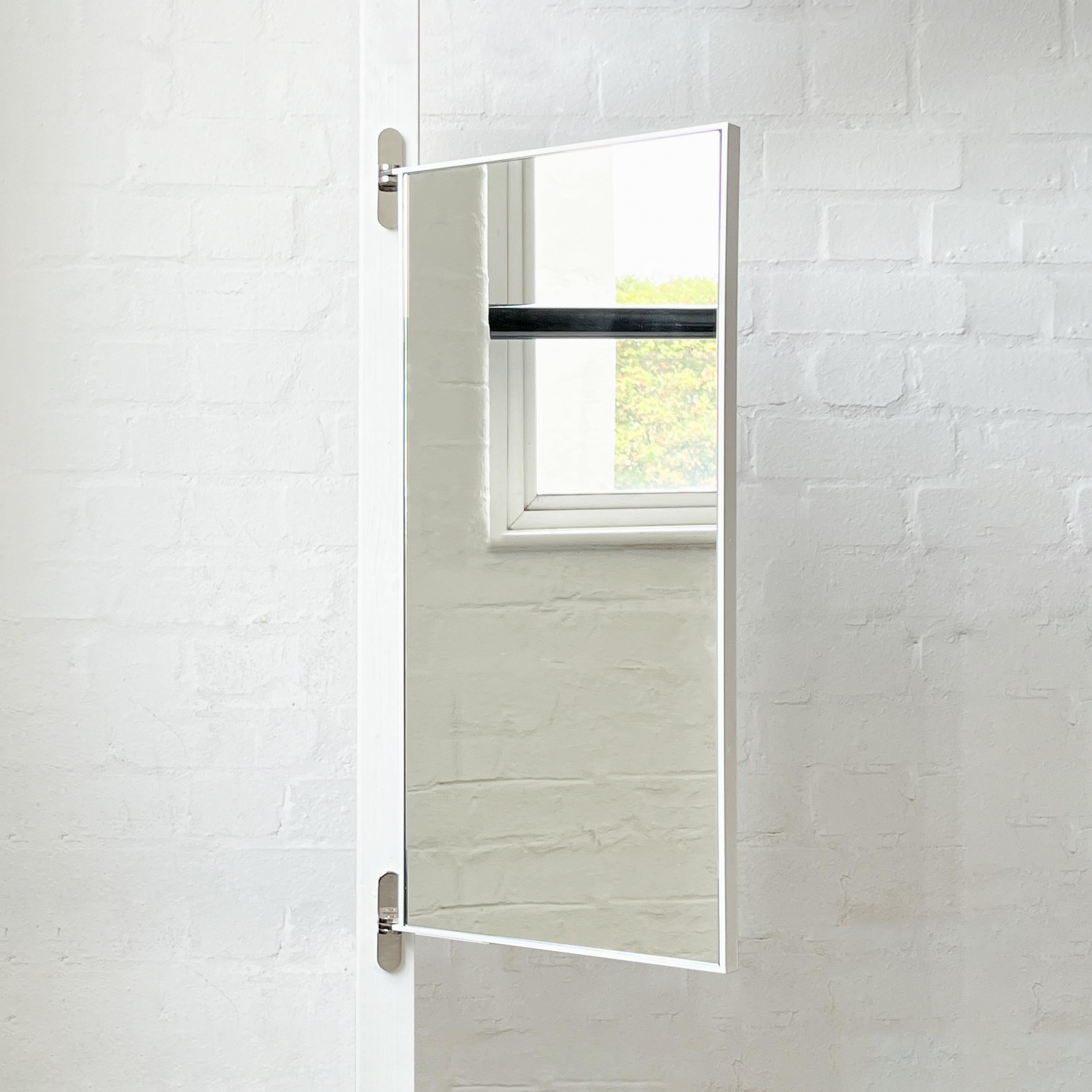 Modern rectangular Porta™ wall mirror with nickel plated hinges and a white minimalist powder coated white frame. Designed and handcrafted in London, UK. This mirror is fully customisable.

Our new hinged Porta™ wall mirror is an ideal solution for