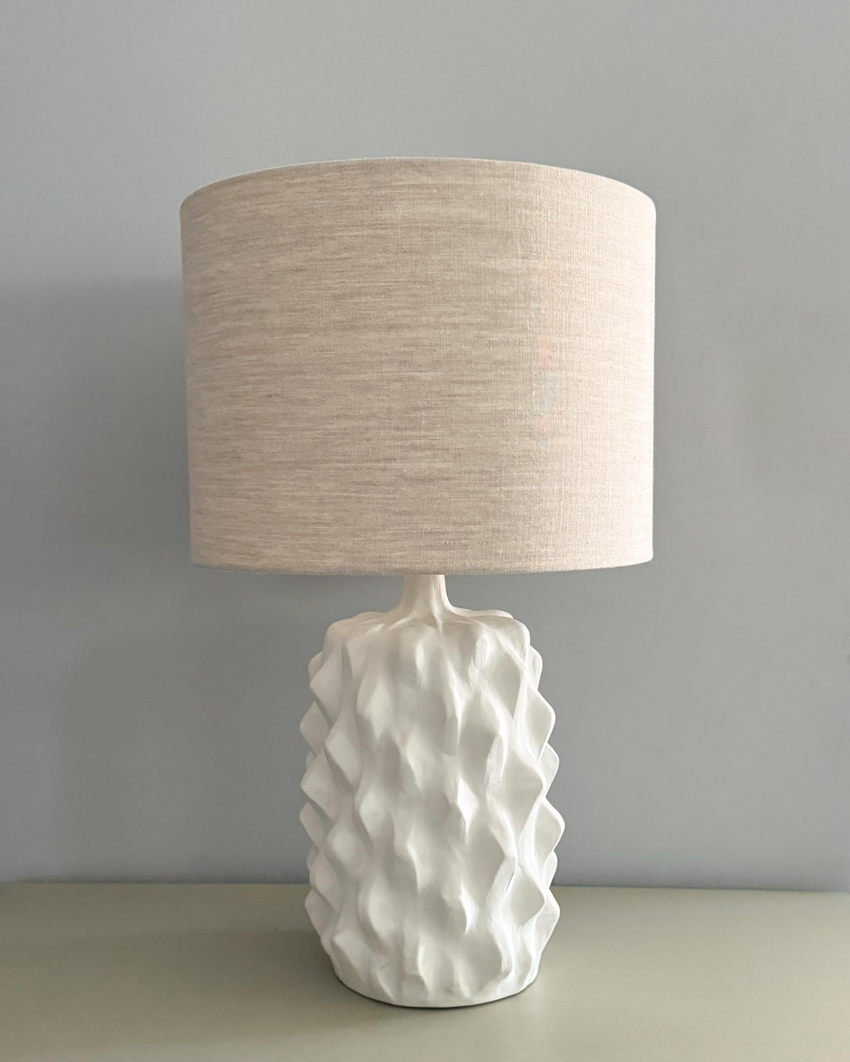 Stunning, biomorphic ceramic table lamp in a white plaster finish by Porta Romana. Made in England.

Original linen shade measurements: 11 3/4” H x 16” D

Preowned, like new condition. 

“The Baobab Lamp is inspired by the form, shape and texture of
