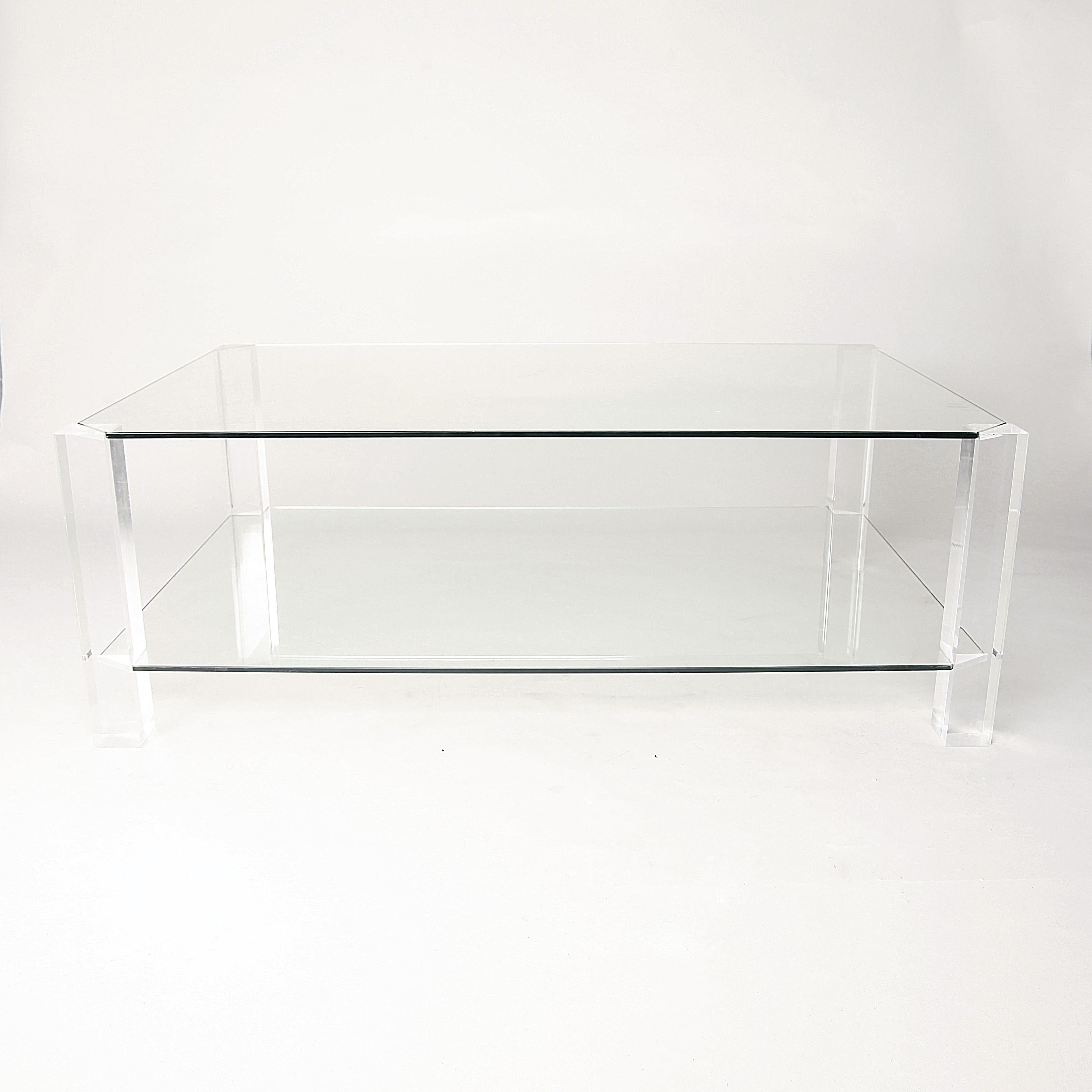 An almost invisible rectangular two-tier glass and Lucite coffee table, designed by Andrew and Sarah Hills for Porta Romana. Square Lucite legs with glass top and tier. An amazingly minimal and modern coffee table. The table authenticated by Porta