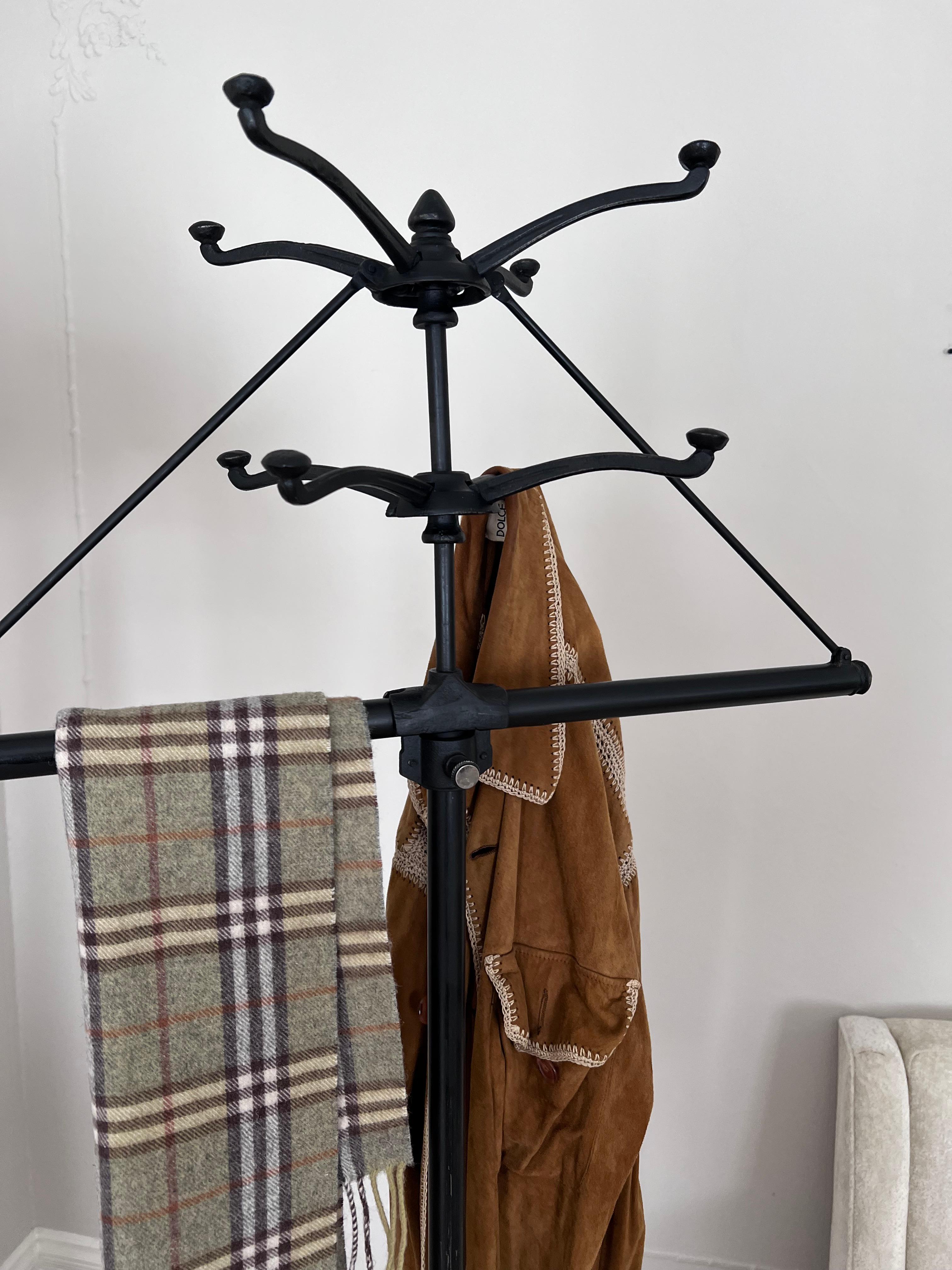A remarkably convenient, portable, collapsable, Coat or Hat Rack. The piece, from the 1930's is made of metal and iron - the height comes apart making it half the height for storage and all pieces collapse for easy traveling. 

This unit could be