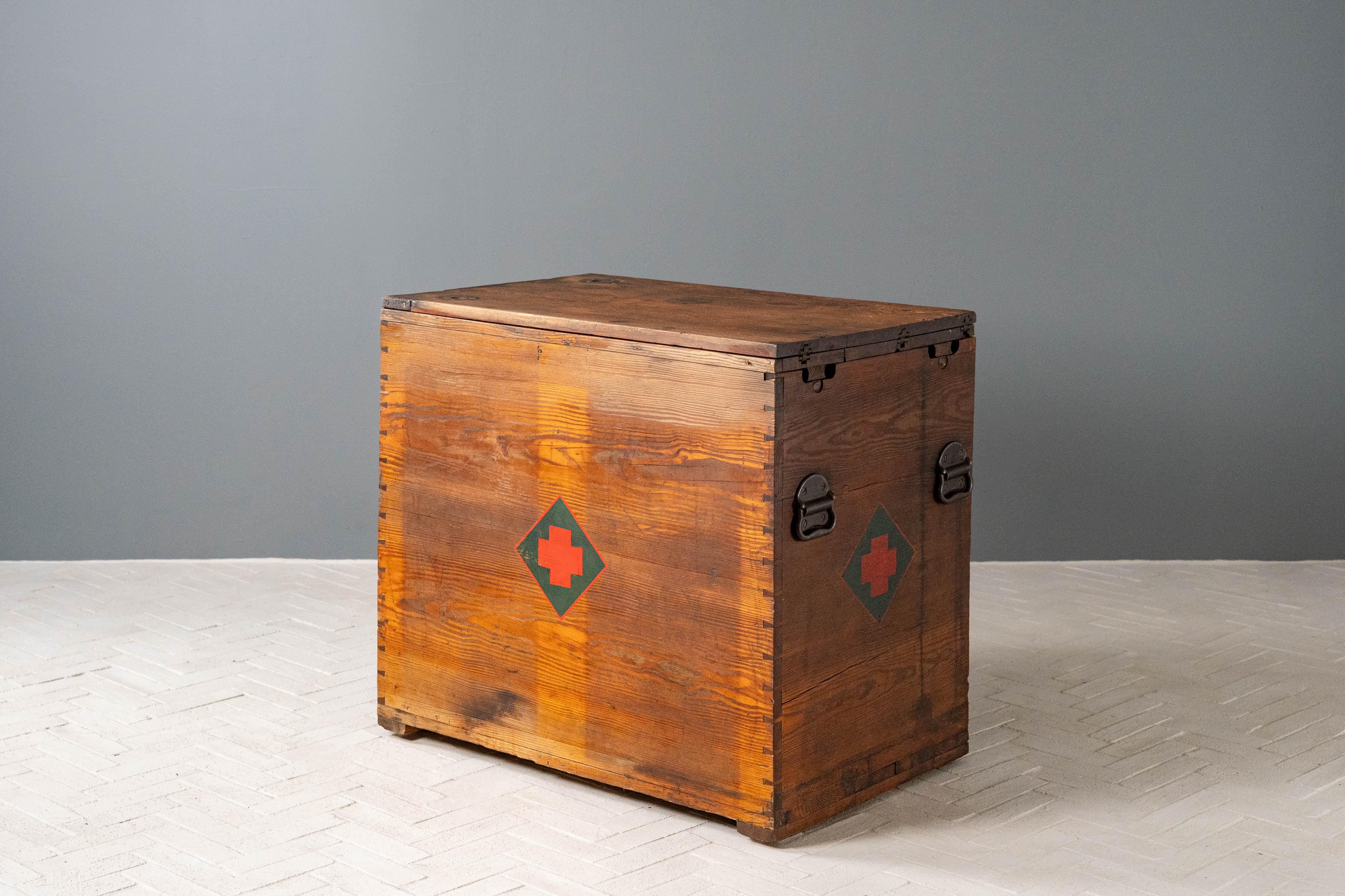 USA, ca. 1930s or 1940s. An incredibly well-built campaign chest or field desk. Features solid wood construction with three large dovetailed drawers and one deep cabinet. Heavy iron pulls and corner braces enhance overall rugged appeal. Top flips