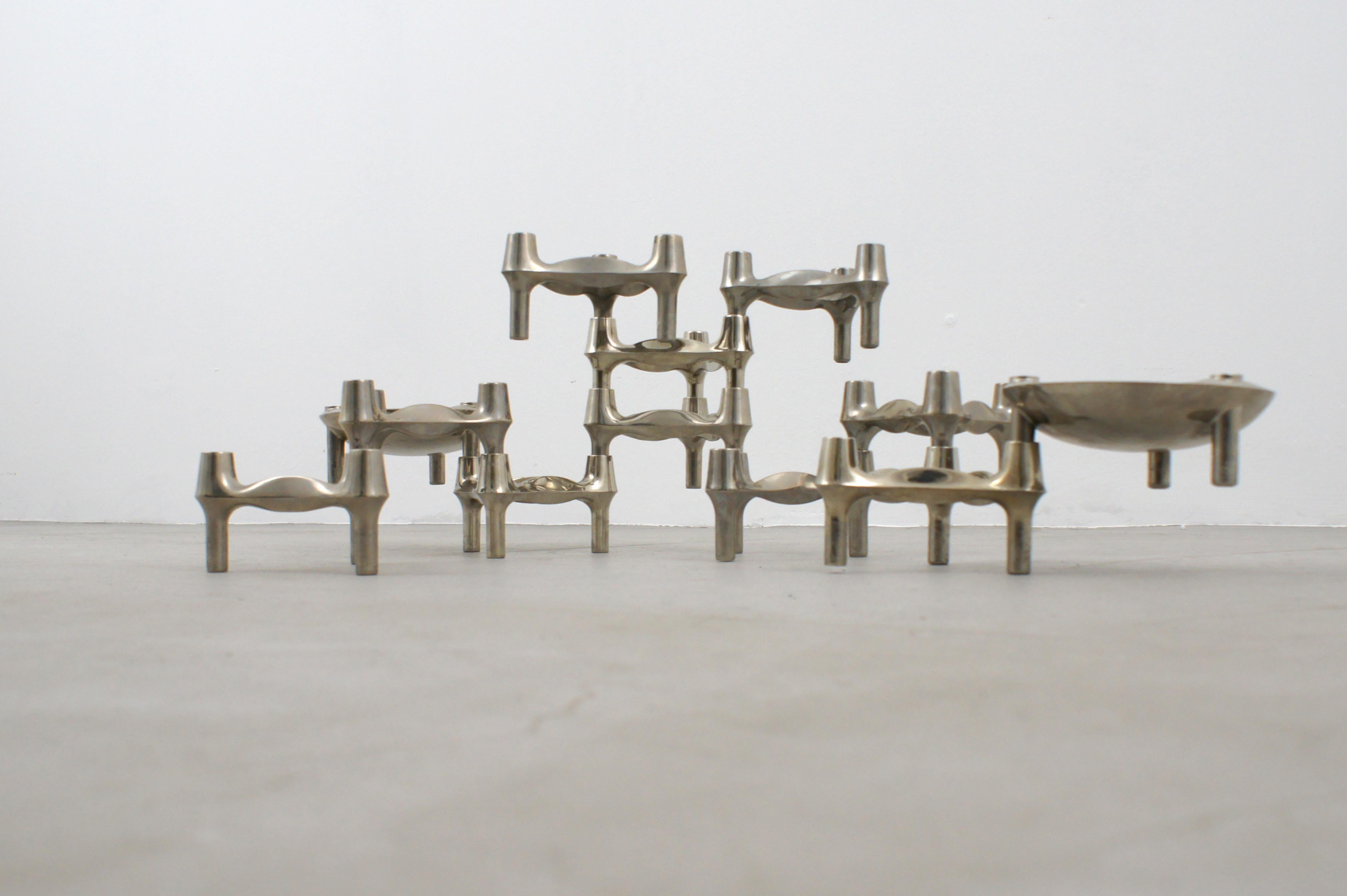 Galvanized metal candle holder set produced by BMF Nagel in the 1960s based on a design by Fritz Nagel. 

Because of their shape, the modules can be assembled into many forms to create an ever-changing sculptural object.

This set consists of 12