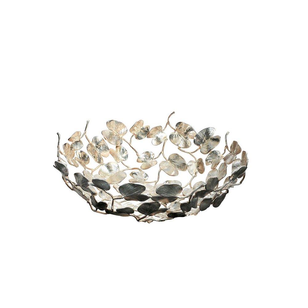 Portafrutta Kachnar II disegnato da Singh Mann e prodotto da Driade nel 1994. Con una struttura completamente in ottone color argento, questa Bowl si caratterizza per la sua forma botanica, composta da intrecci di fiori e foglie legate fra loro. In