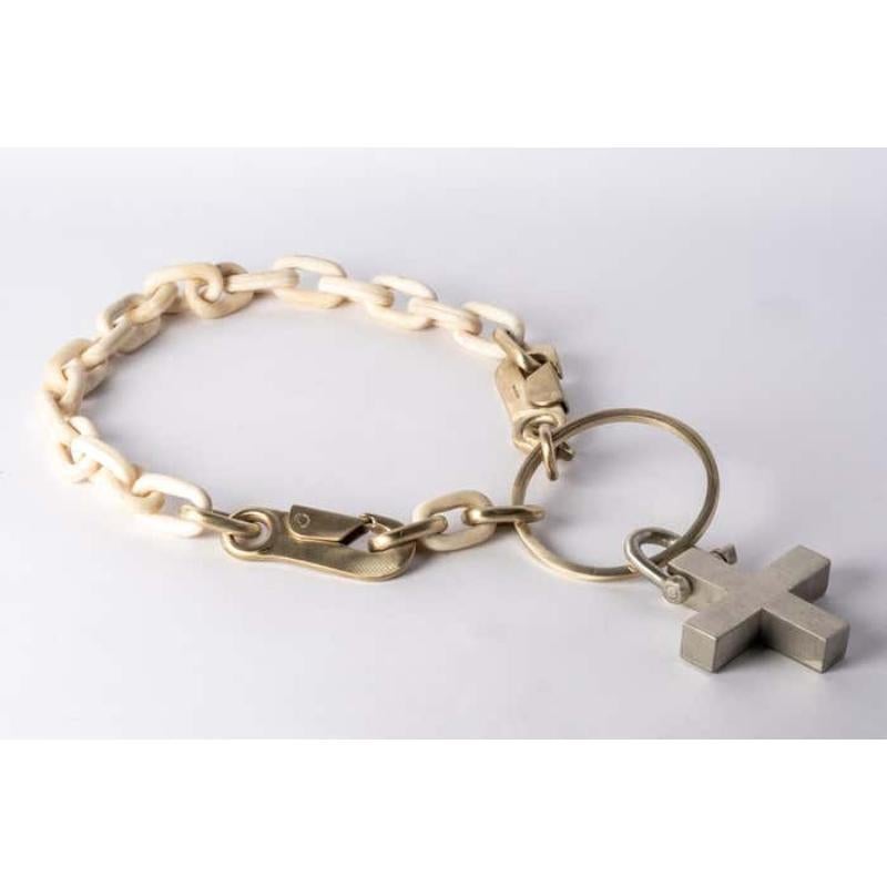 Chain necklace made of a combination of brass, bronze and bone. All organic chain is carved by hand. Chains made from bone are modeled and constructed into chain links.
The Charm System is an interrelated group of products that can be mixed and