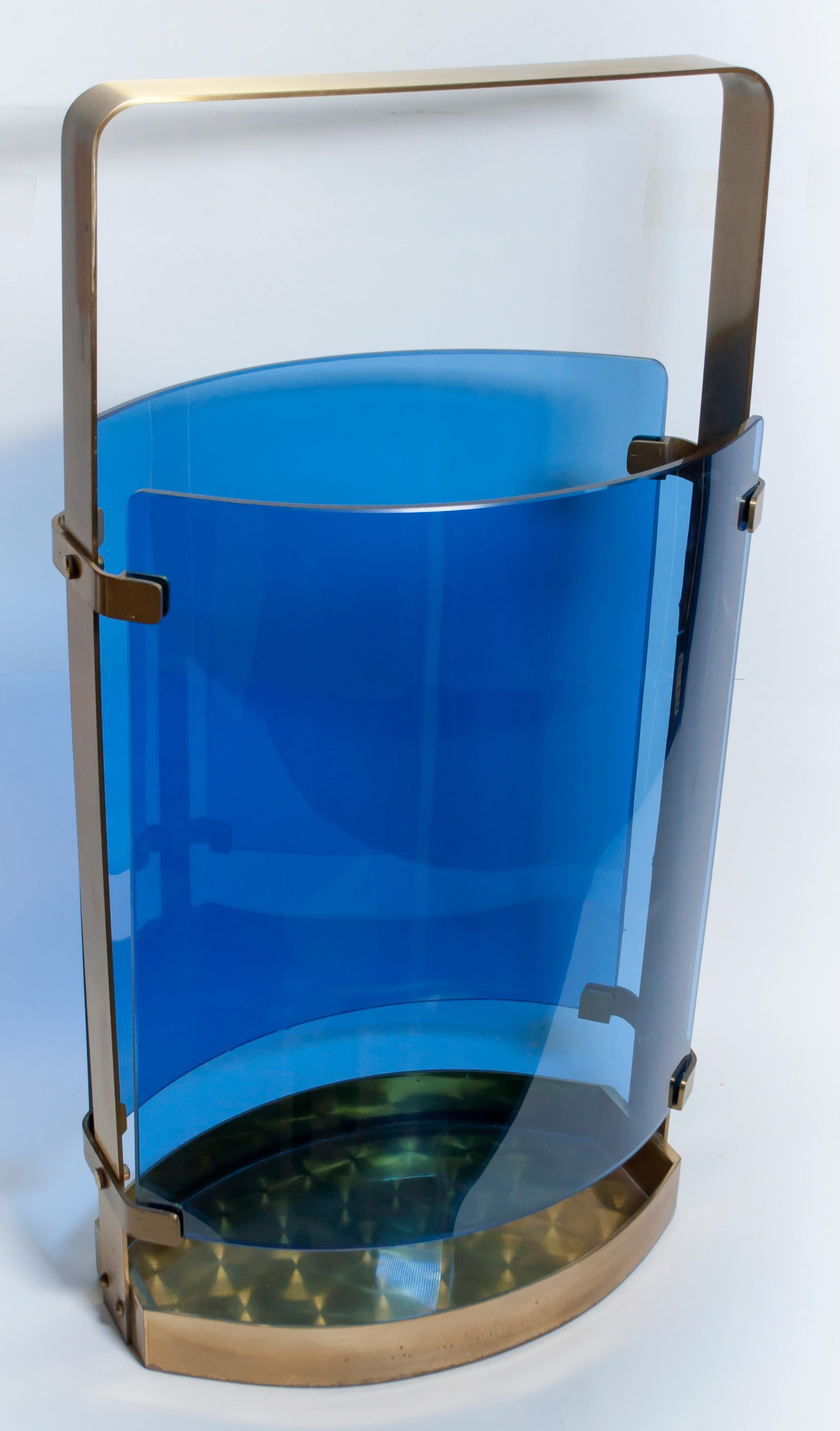 This umbrella stand in blue bent glass and polished brass, was designed by Max Ingrand for Fontana Arte, produced in the early 1960s in Italy.

Max Ingrand; 2035A Brass and Glass Umbrella Stand for Fontana Arte, 1964.

Max Ingrand, whose full name