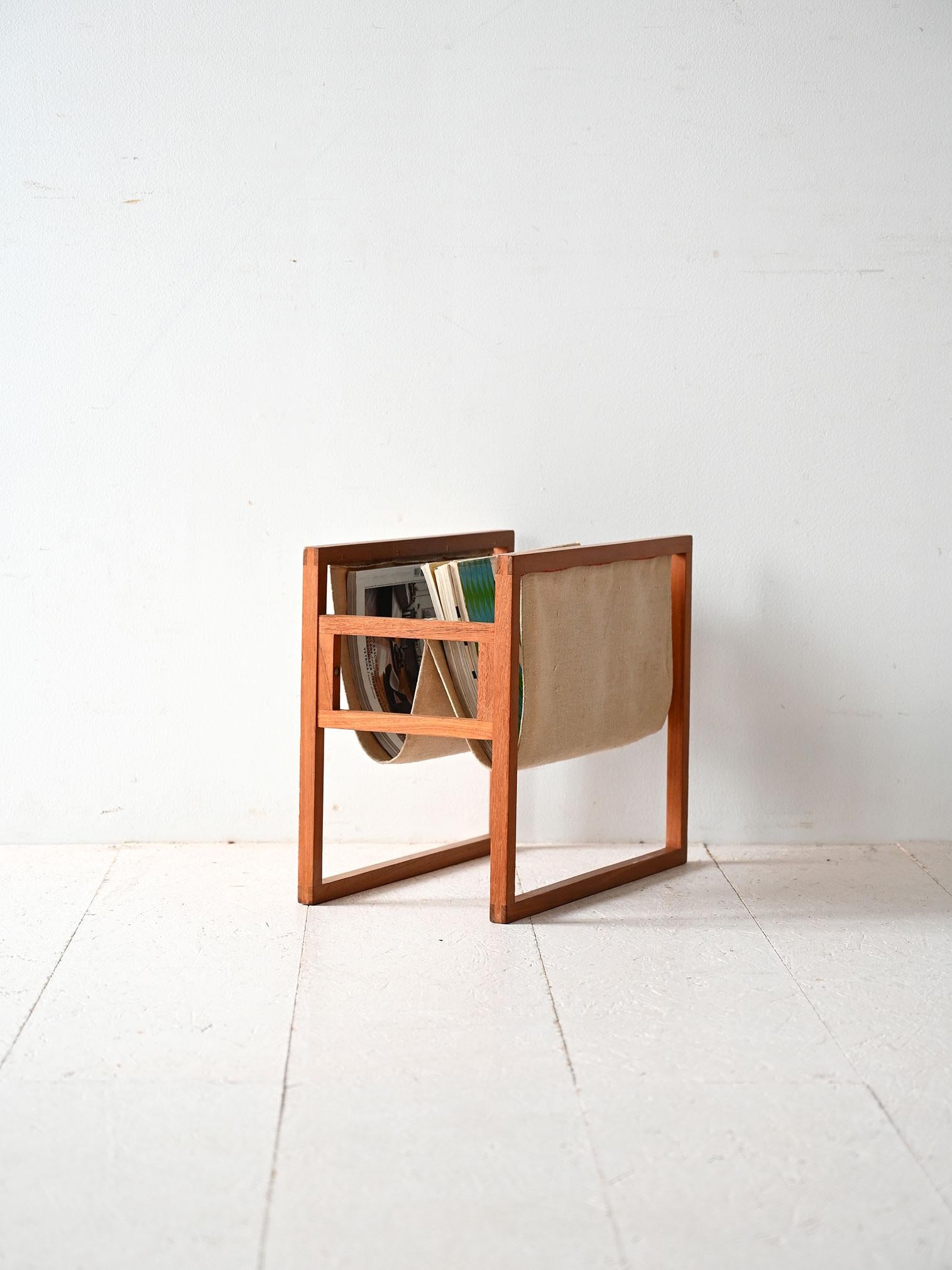 Scandinavian 1950s-60s magazine rack by Henning Wind-Hansen. Teak frame with fabric bag, elegant and functional.

This vintage magazine rack, by Danish designer Henning Wind-Hansen, is a fine example of Scandinavian design from the 1950s-60s. The