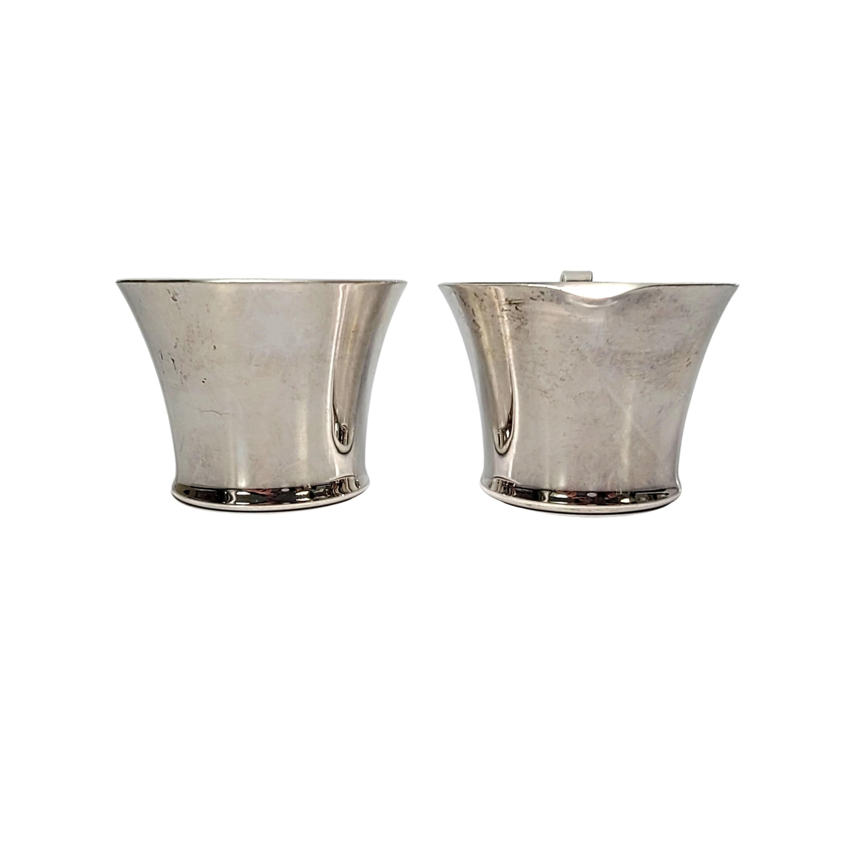 Sterling silver open creamer and sugar bowl set designed by Porter Blanchard.

Designed by Porter Blanchard, a prominent California silversmith in the Arts and Crafts tradition from 1930s-1970s.. A beautiful and simple design with classic, timeless