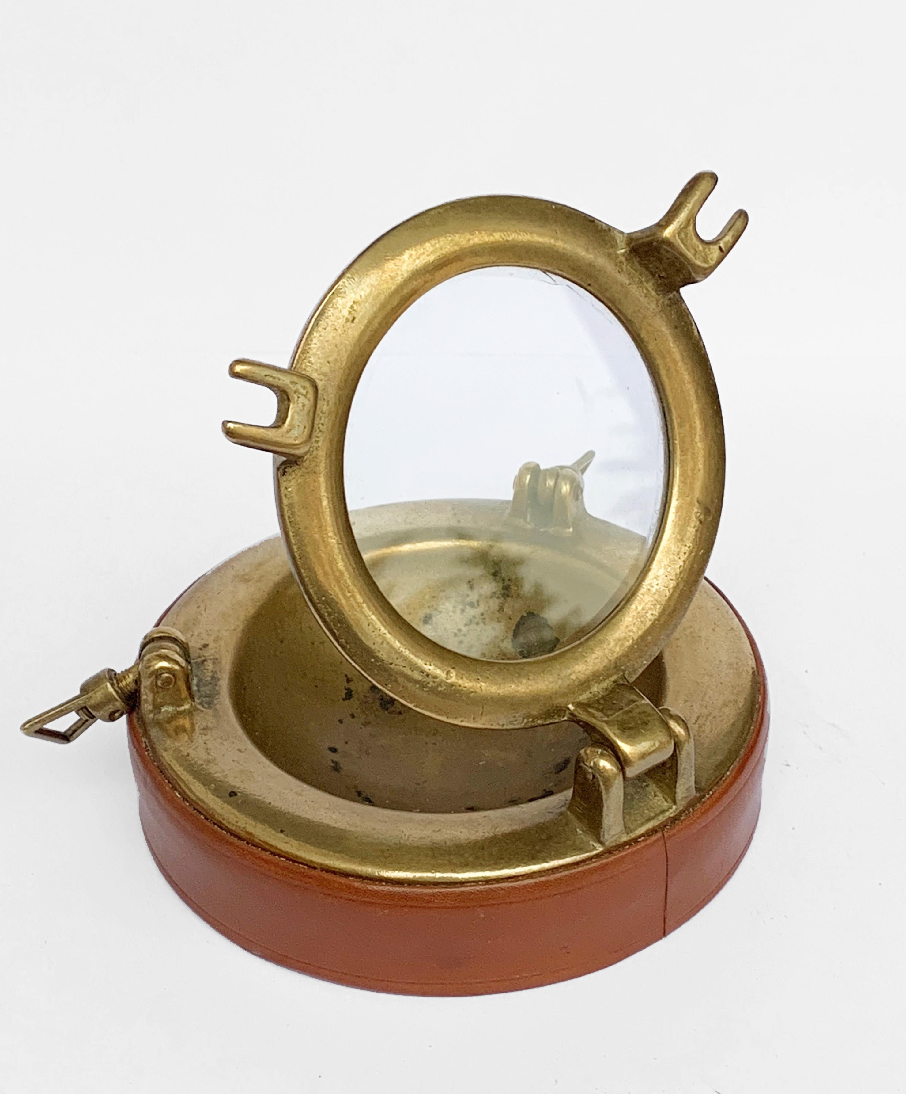 Ashtray in brass and leather, 1960s Designed by Gucci, Italy 1960s
Ashtray in brass, leather and glass, porthole shape of the ship, with a top that can be opened. Italian 1960s. Designed by Gucci.