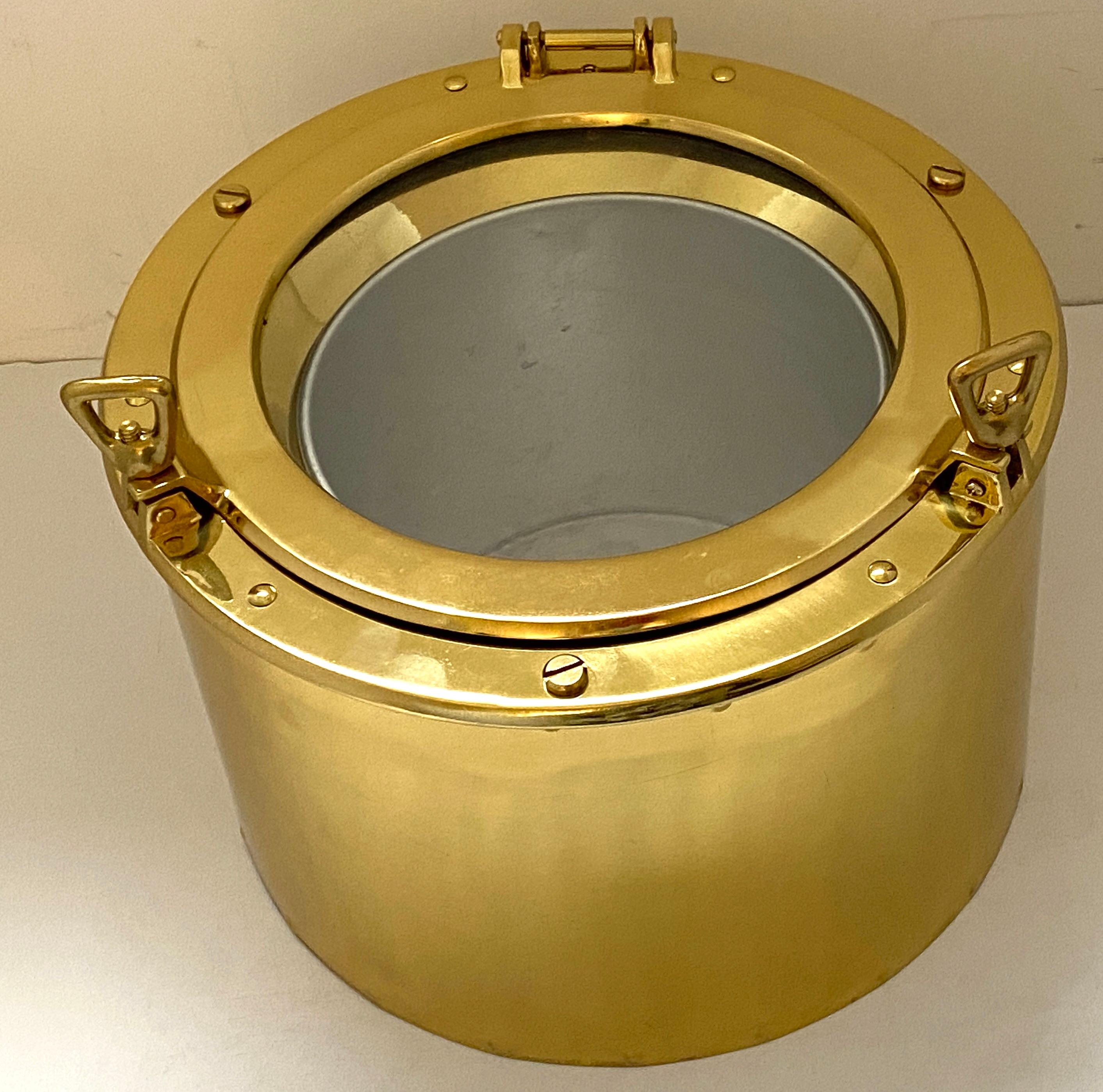 This stylish brass ice bucket from the 1970s-1980s is the perfect piece for summer gatherings on the beach with its nautical port-hole form.

Note: To open twist the two knobs and the lid is supported with a hinge (see photos).

Note: The