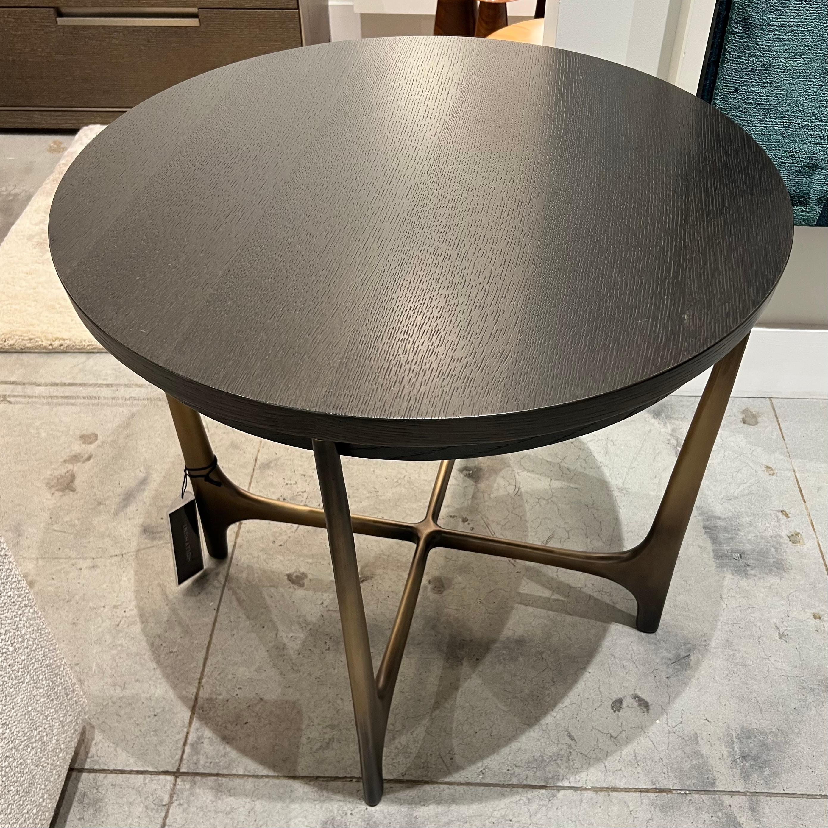 Inspired by the avant-garde modernism of Oscar Niemeyer, the Portia Side Table appears both sensuous and structured. The cast-bronze base supports a rounded wood or stone top that gives the table streamlined appeal. Whether in a pair or on its own,