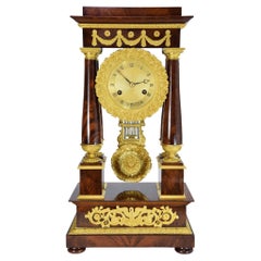 Antique Portico clock in mahogany and bronze mercury gilding 1840