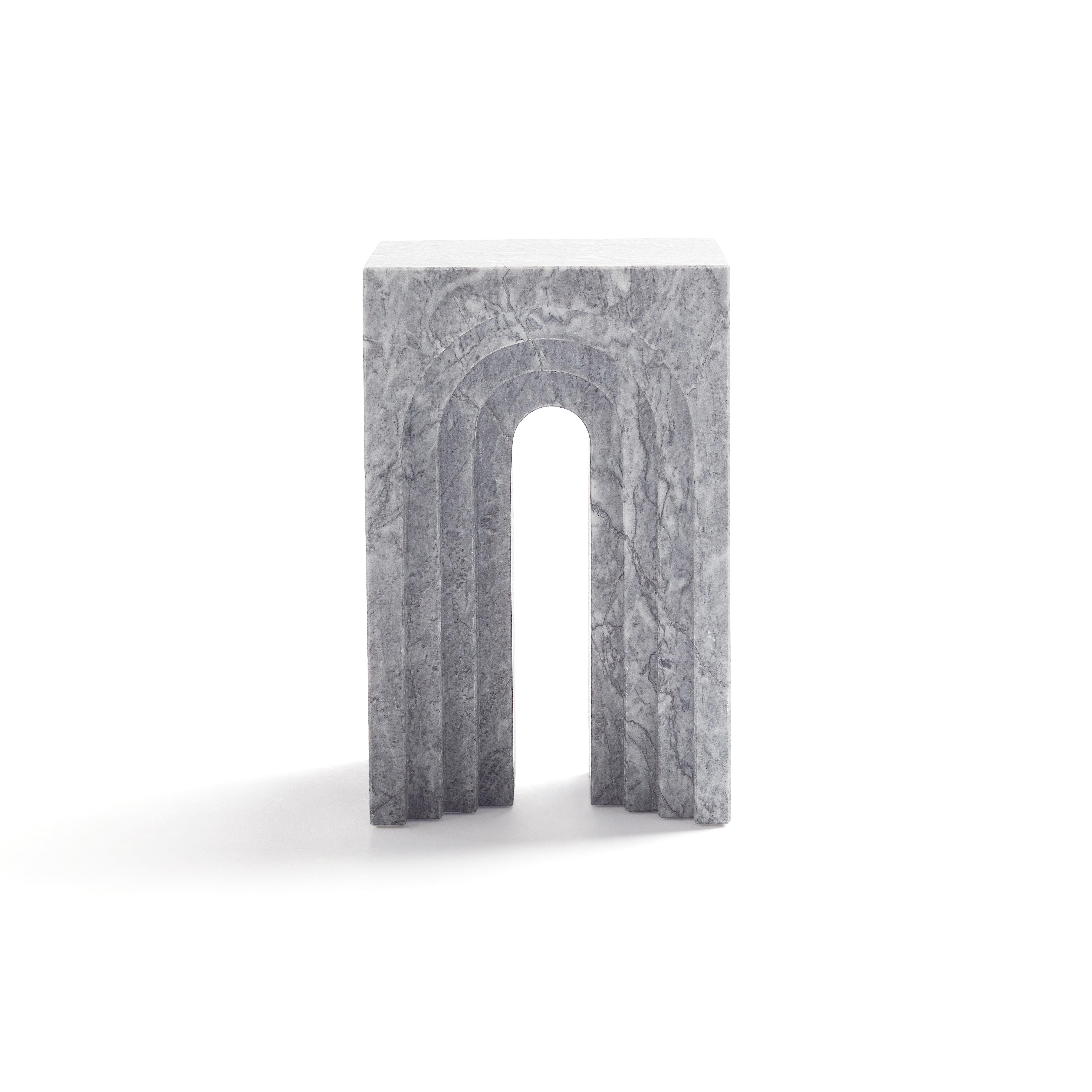 Portico is a robust, brutalist, minimalist and eternal stool/side table. The arches created by the doors on both sides, concentrate the light in a central point, and gives the viewer a poethic minimalist enlightening sense. Josep Vila Capdevila,