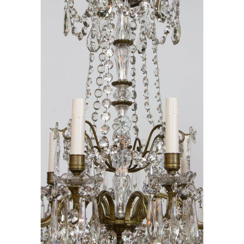Bronze and crystal chandelier by Cristallerie de Portieux. A single tier of candles. Cut crystal stem pieces with a brilliant sparkle. Completely restored, wax polished to protect and clean the patina. Rewired with new sockets and candlecovers.