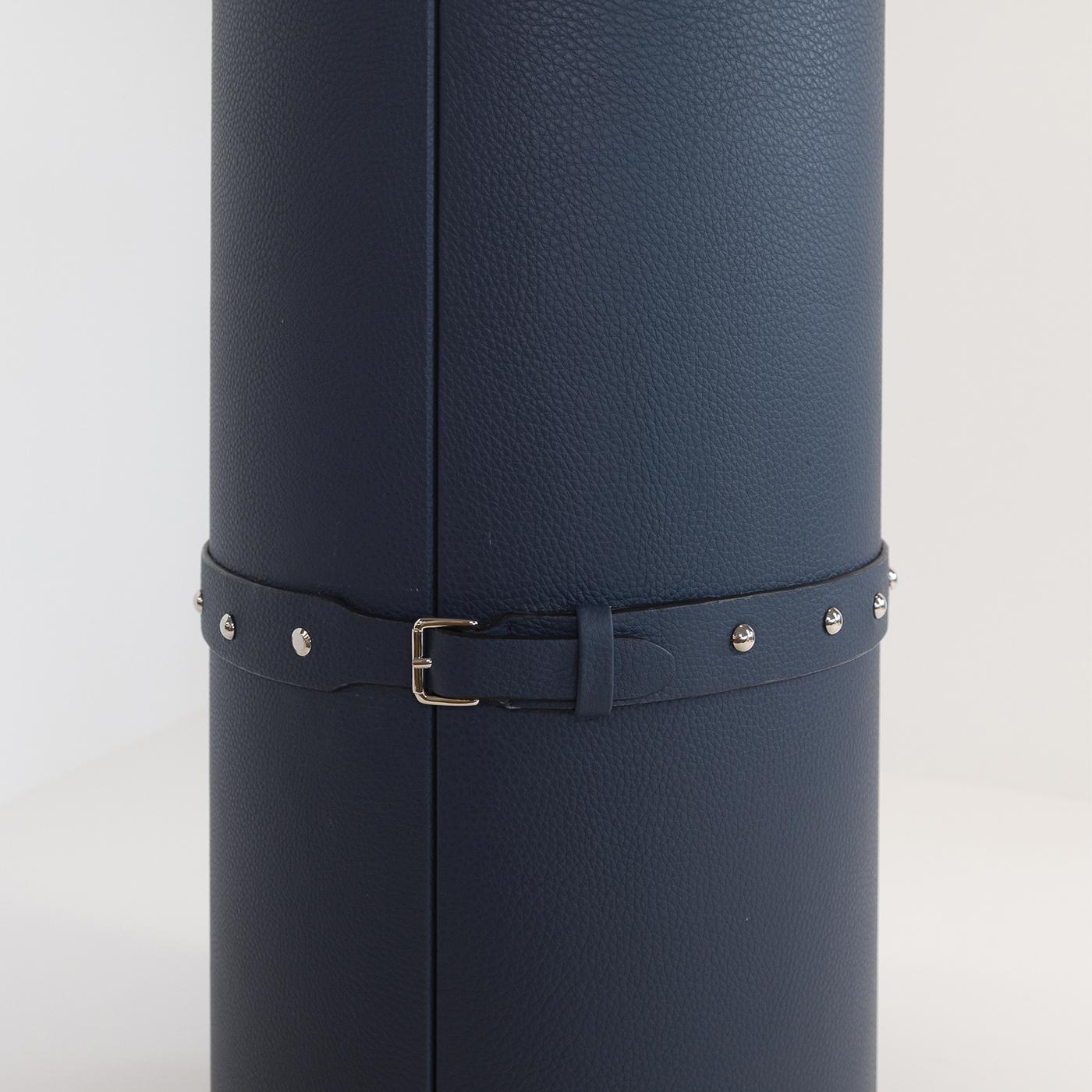 This beautiful yet practical cylindrical wine box is covered in fine, full-grain leather and is completely handmade. Genuine Alcantara lining on the inside of the box and metal detailing and a buckle closing on the outside complete the look of this