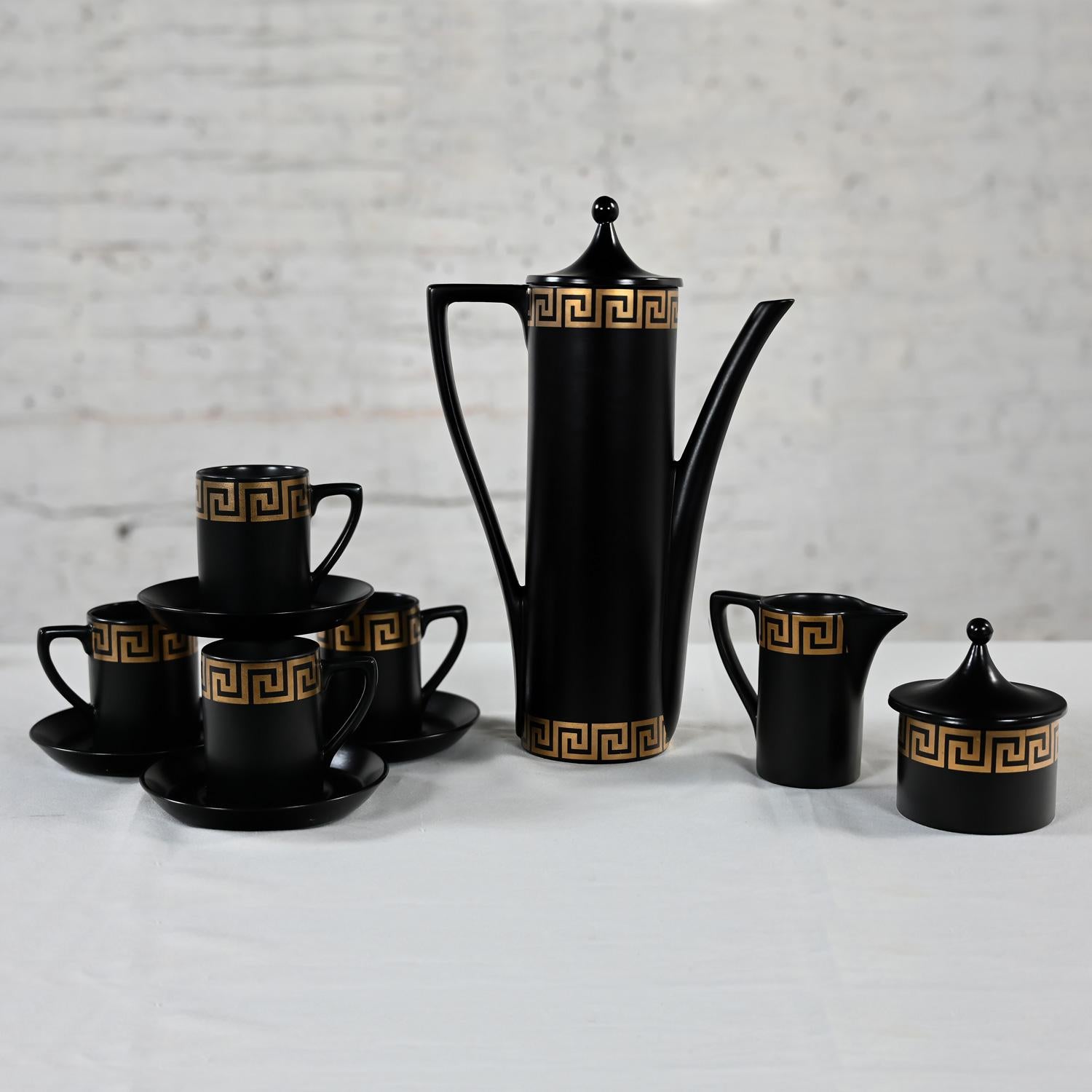 Incredible vintage MCM (Mid-Century Modern) to Modern Portmeirion Pottery espresso coffee service with demitasse cups in black and gilded Greek Key detail by Susan Williams Ellis Designs. Comprised of 1 tall coffee pot with a lid, 1 creamer, 1