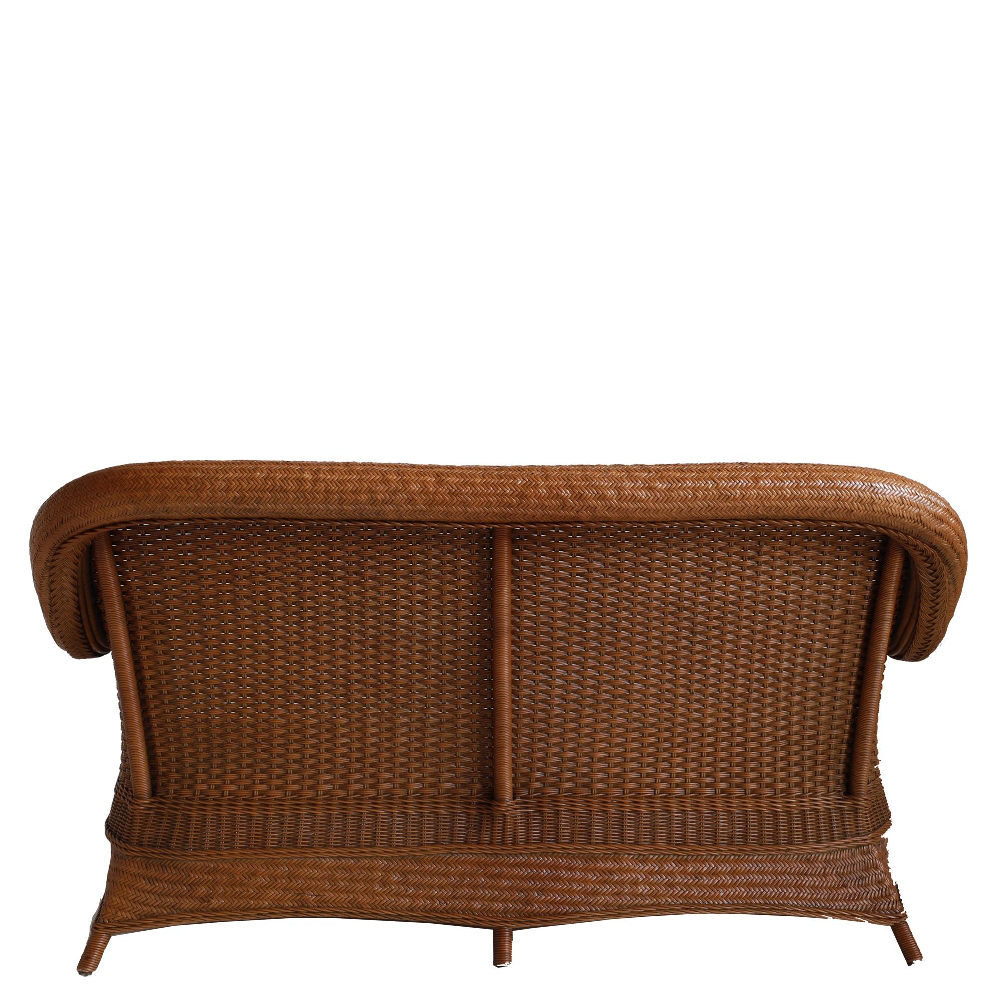 Hand woven rattan and cane sofa.

White cotton cushions included.

Handcrafted product with natural fibres. Finish and colour will vary in each piece.

Dimensions:-

H 95 x W 180 x D 90 cm
Seat – H 46 x D 66 cm
Arm height – 65 cm