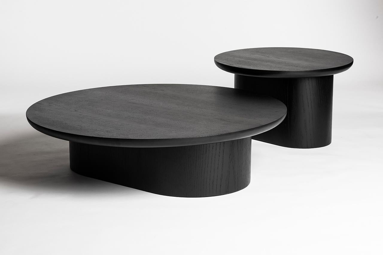 Set composed of a Porto center table and a porto side table
Dimensions: Center table D 115/ H 29 cm - Side table D 70/ H 40 cm 

Porto low tables are composed of a circular top that seems to rest on a sturdy oblong base. Lightness and weight