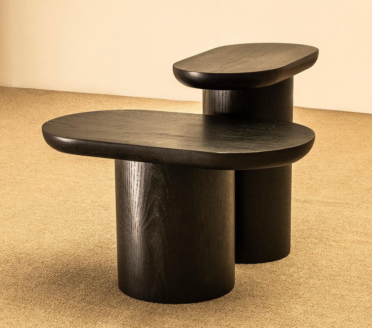Set composed of two Porto side tables, a high and a low.
Dimensions: High table L 45/ W 25/ H 45 cm - Low table L 60/ W 32/ H 34 cm 

Porto low tables are composed of a circular top that seems to rest on a sturdy oblong base. Lightness and weight