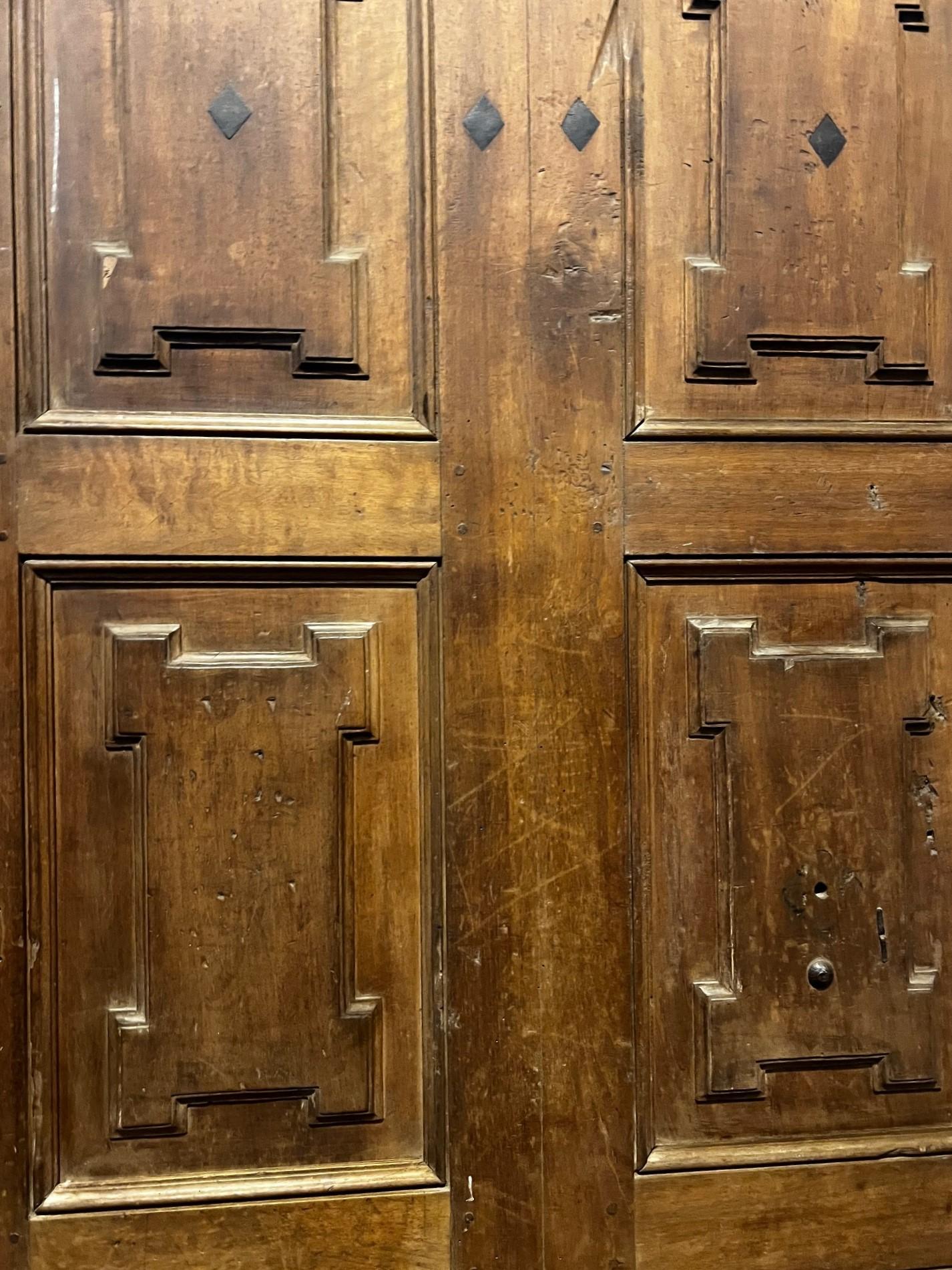 Italian One-door walnut front door with carved panels For Sale