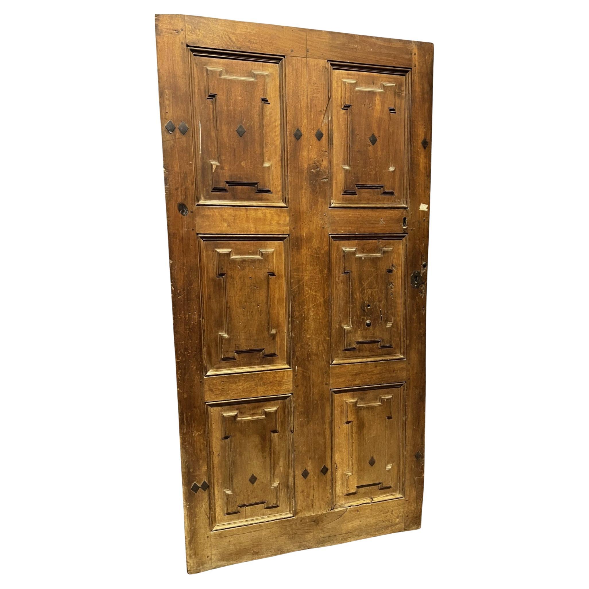 One-door walnut front door with carved panels