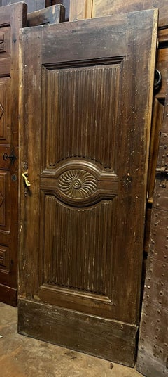 walnut front door, grissinized and carved panels with central flower