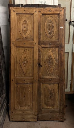 Double-leaf carved front door with carved geometric panels, Italy