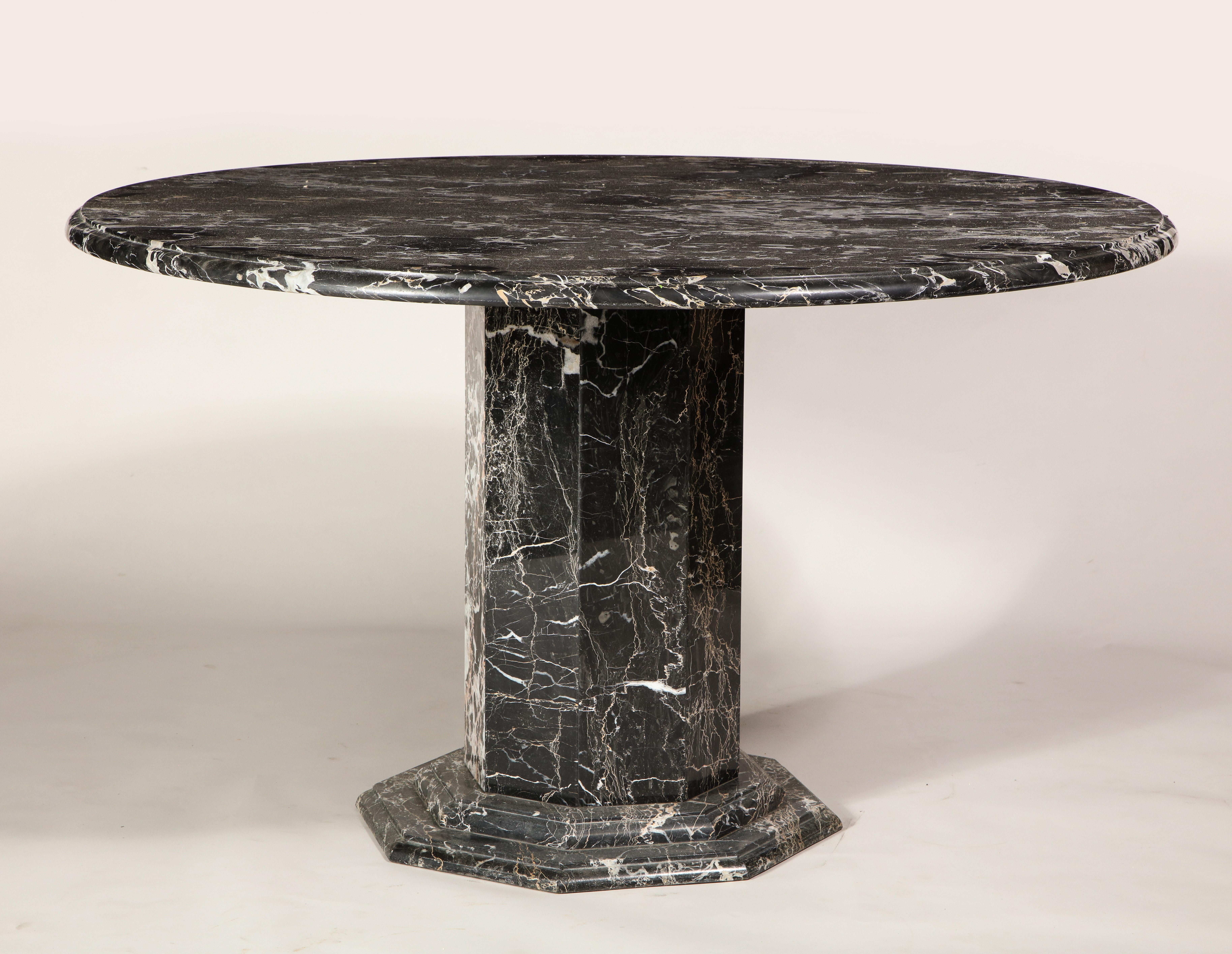 Portoro deco style black marble round centre, game dining, table, France, 1980s.

Beautiful dining or centre Table in black Portoro marble. Gold, white and black, France, 1980s. The table comes apart in two pieces for shipping. 
Imported from